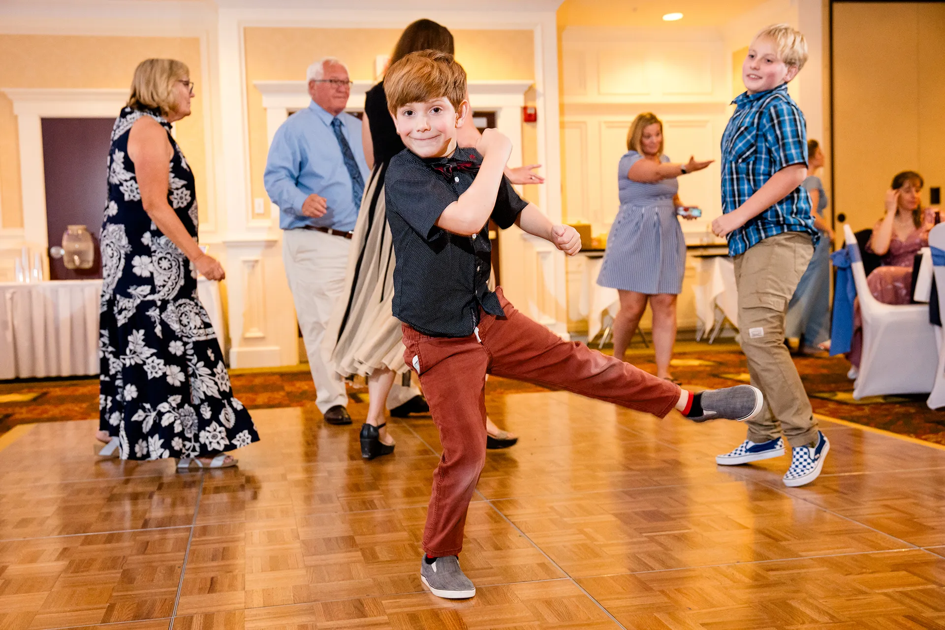 A young boy smiles and dances during a wedding reception at Hilton Garden Inn in Bangor, Maine.