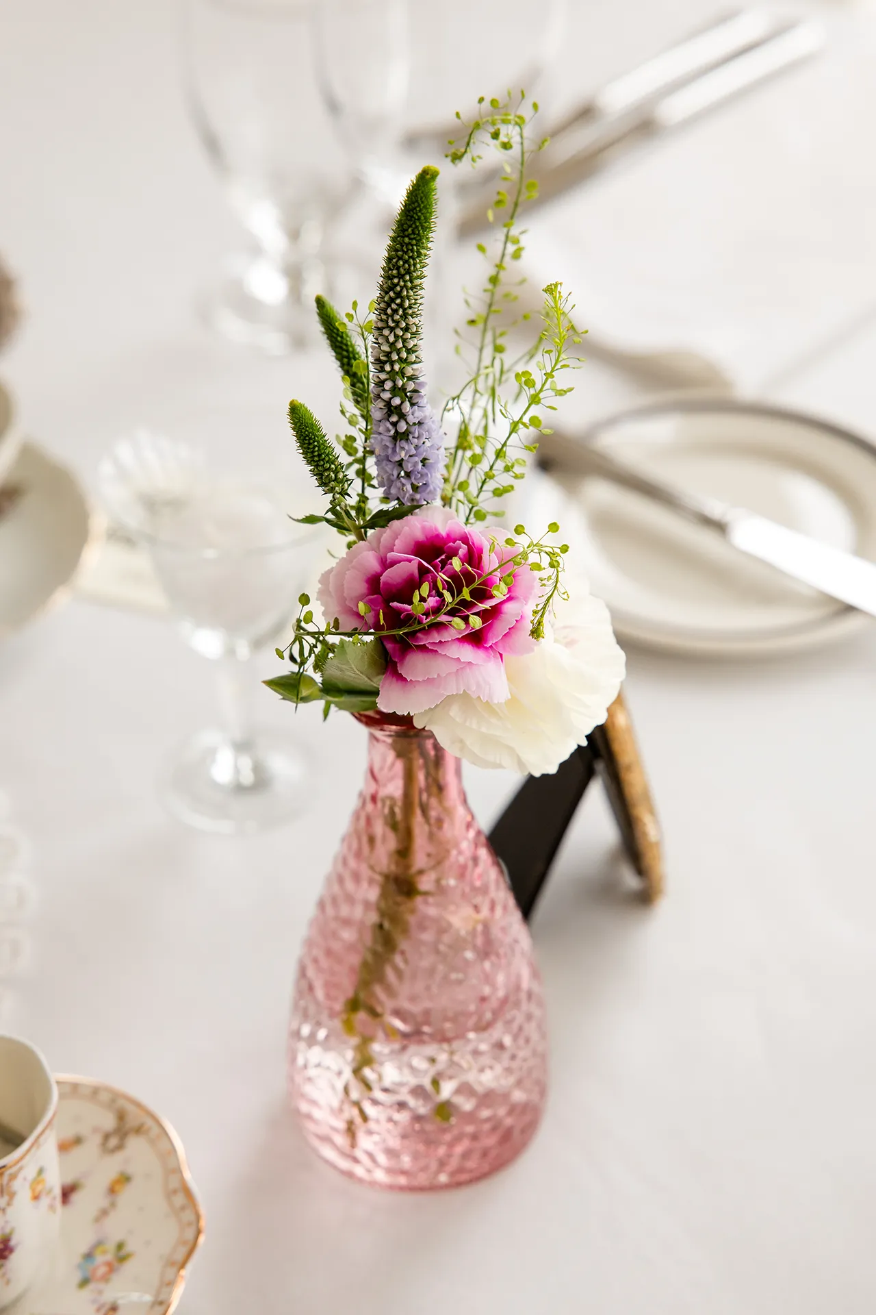 maine wedding photography bethany mike 05 A closeup of a pink flower in a pink vase for a garden party themed wedding at the York Harbor Reading Room in Maine.