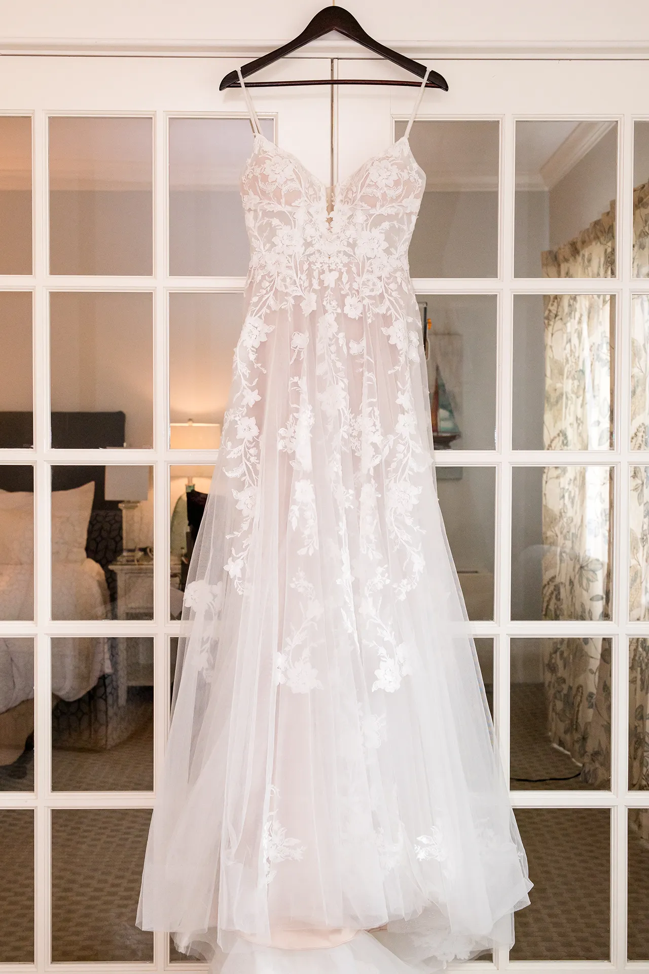 maine wedding photography bethany mike 11 A wedding dress hangs from a door at the York Harbor Inn in York, Maine.