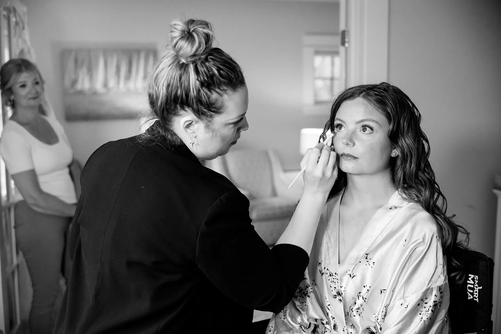 maine wedding photography bethany mike 14 A bride gets her makeup done as her mom watches for a wedding at the York Harbor Reading Room in Maine.
