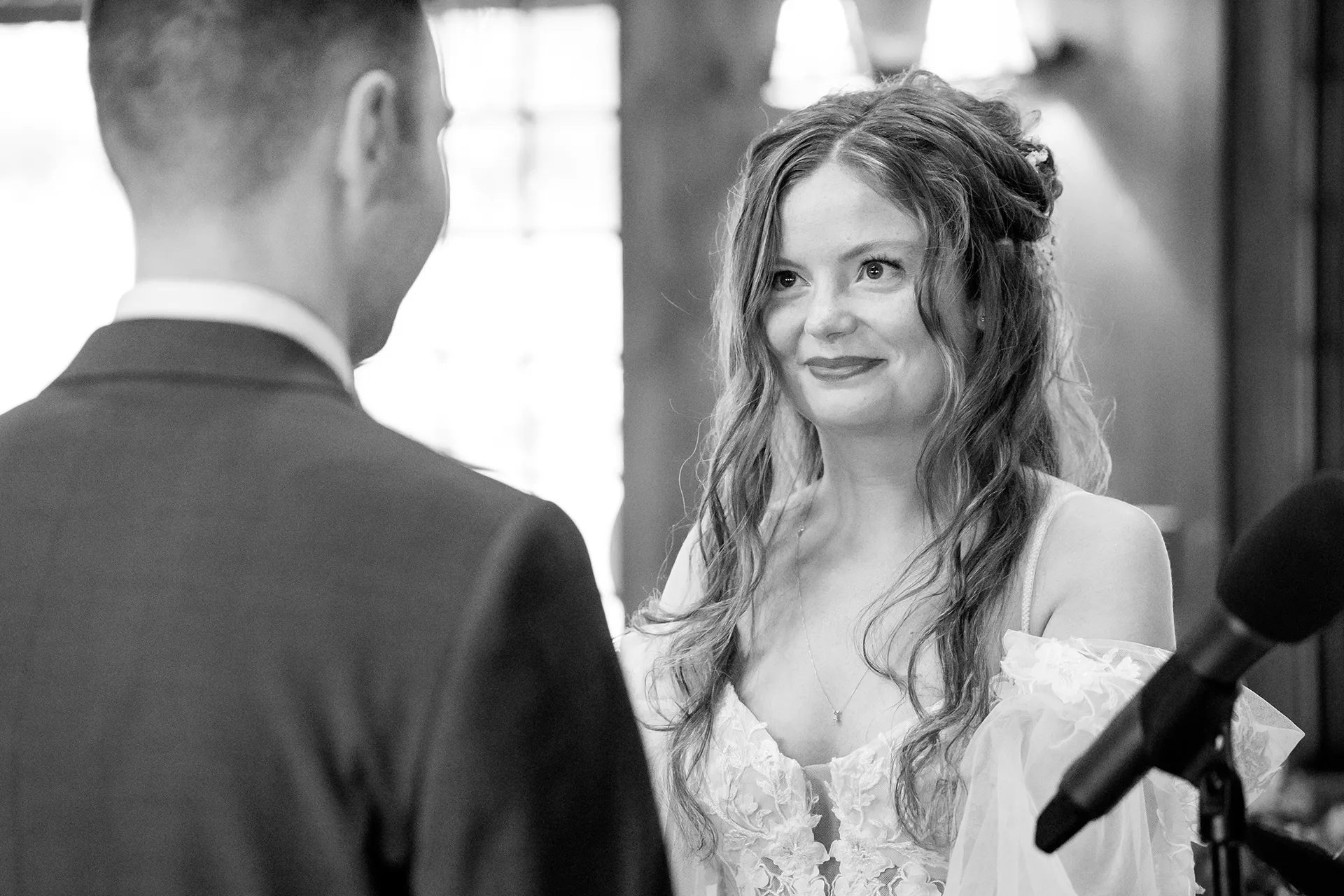 maine wedding photography bethany mike 30 A bride smiles at a groom during a wedding ceremony at York Harbor Reading Room in York, Maine.