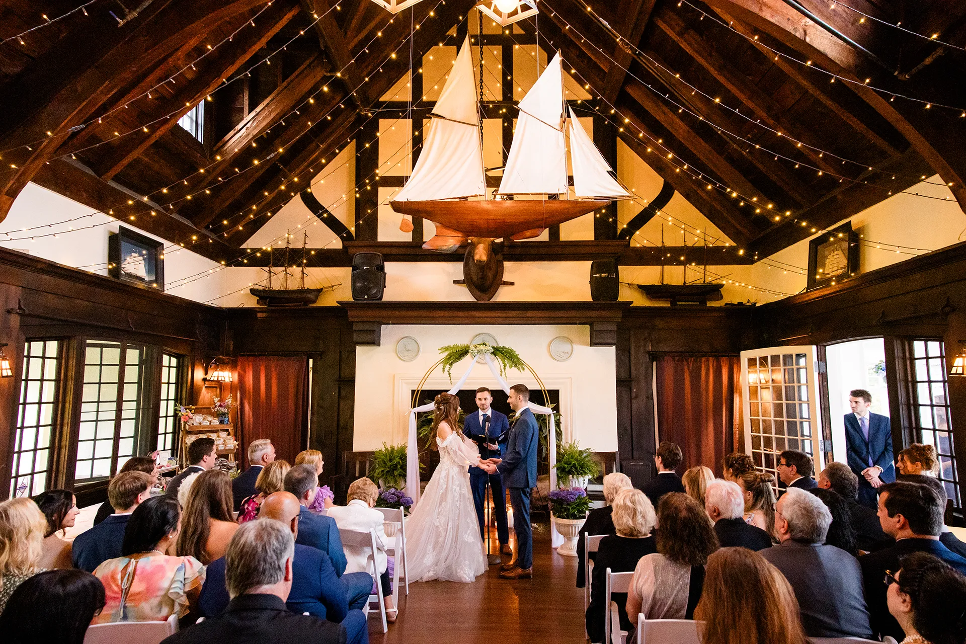 maine wedding photography bethany mike 32 A bride and groom hold hands during a wedding ceremony at York Harbor Reading Room in York, Maine.