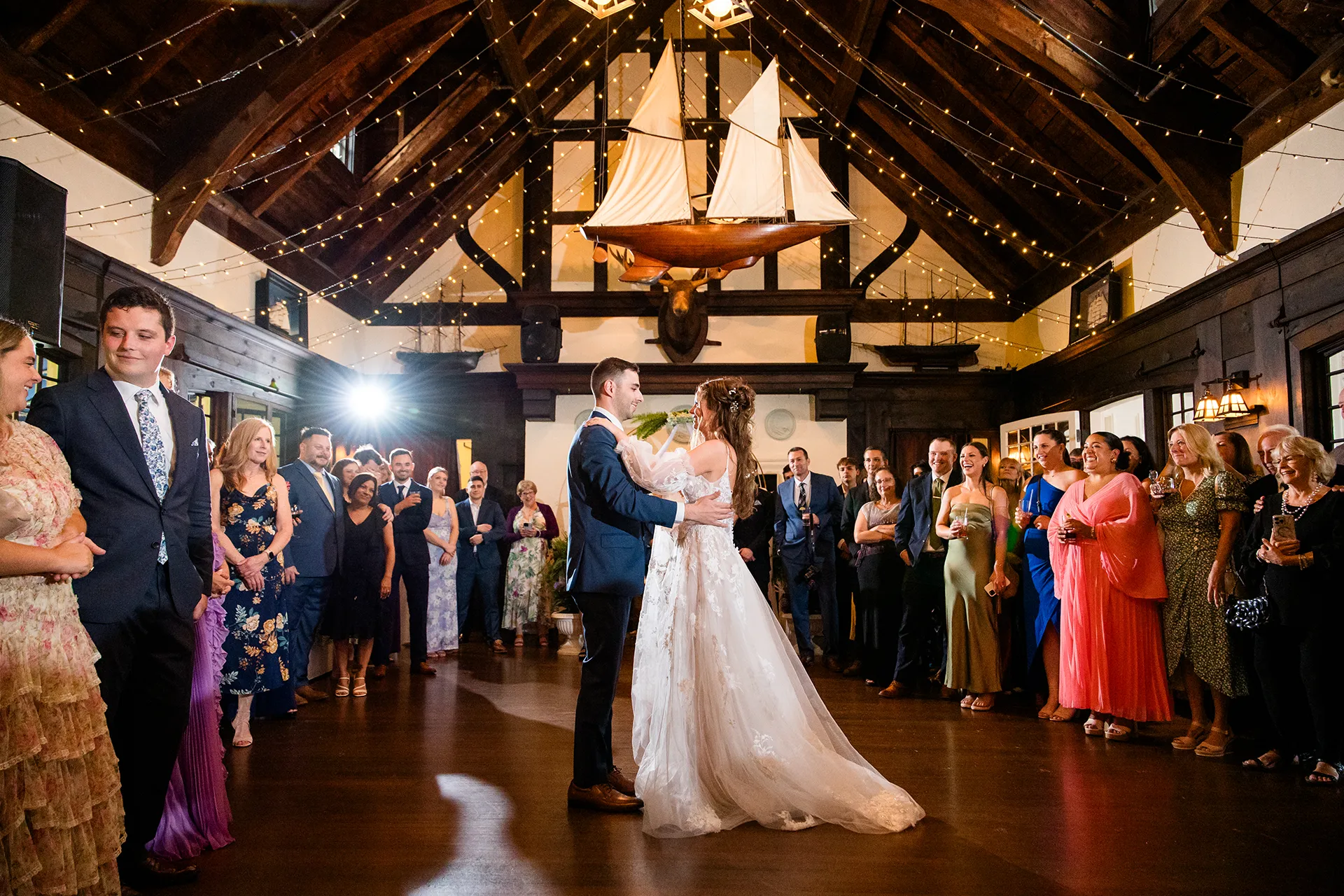 maine wedding photography bethany mike 37 A bride and groom share a first dance as guests watch during a wedding reception at the York Harbor Reading Room in York, Maine.
