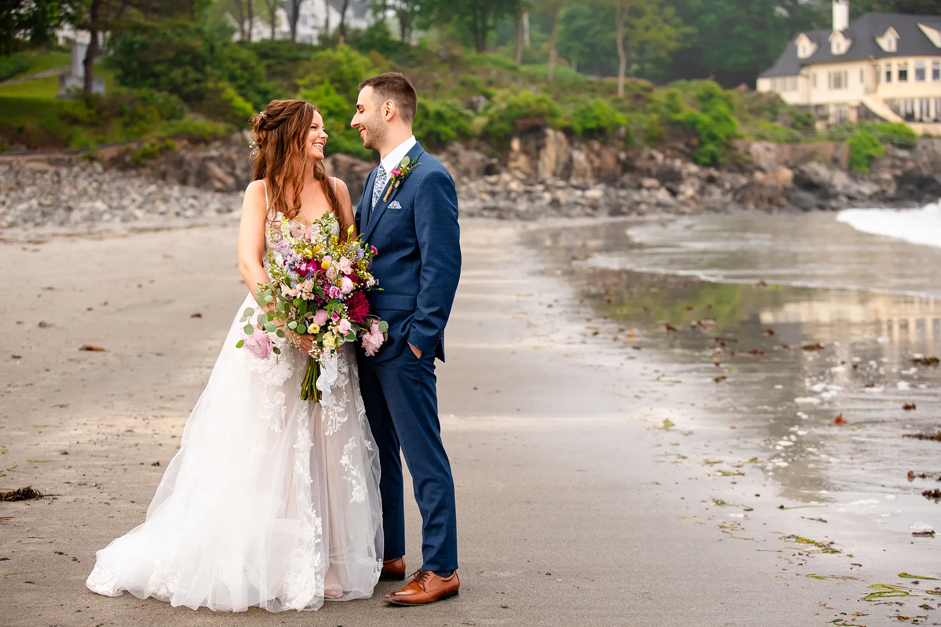 maine wedding photography bethany mike 44 A bride and groom smile at each other during wedding portraits on York Harbor Beach in York, Maine.