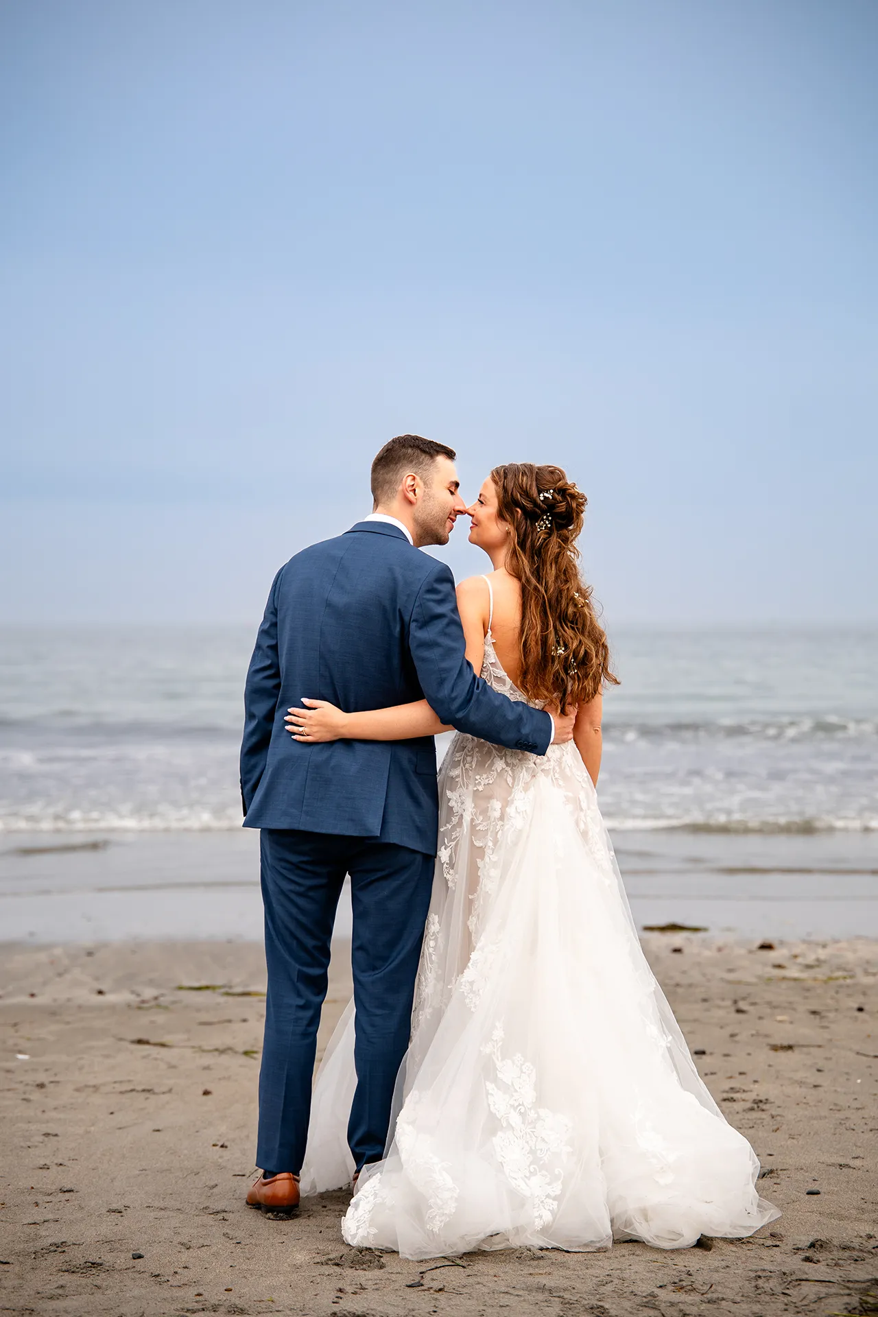 maine wedding photography bethany mike 51 A bride and groom smile and rub noses during wedding portraits on York Harbor Beach in York, Maine.
