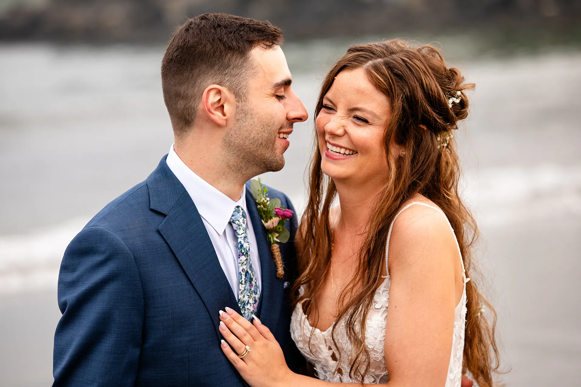 maine wedding photography bethany mike 53 A bride and groom laugh together during wedding portraits on York Harbor Beach in York, Maine.