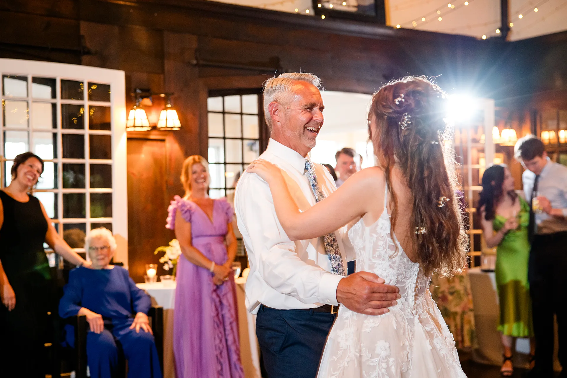 maine wedding photography bethany mike 57 A dad laughs as he dances with a bride during a wedding reception at the York Harbor Reading Room in York, Maine.