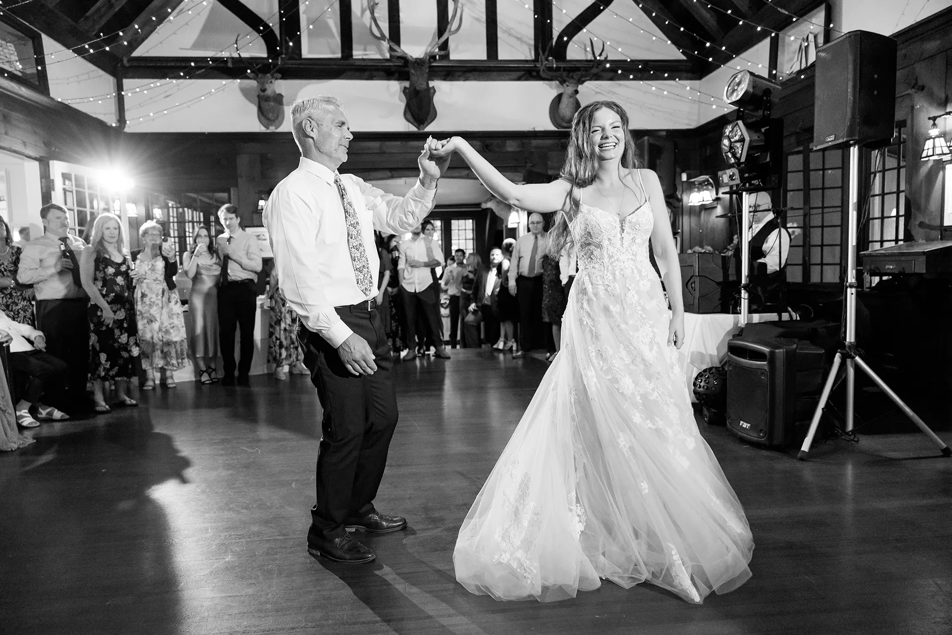 maine wedding photography bethany mike 58 A bride laughs as her dad spins her during a wedding reception at the York Harbor Reading Room in York, Maine.