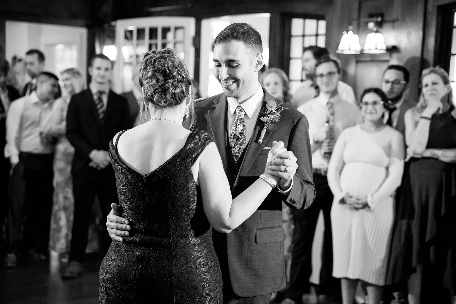 maine wedding photography bethany mike 59 A groom smiles as he dances with his mom during a wedding reception at the York Harbor Reading Room in York, Maine.