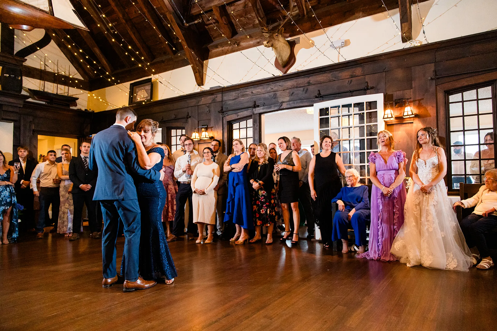maine wedding photography bethany mike 60 A groom dances with his mom as guests watch during a wedding reception at the York Harbor Reading Room in York, Maine.