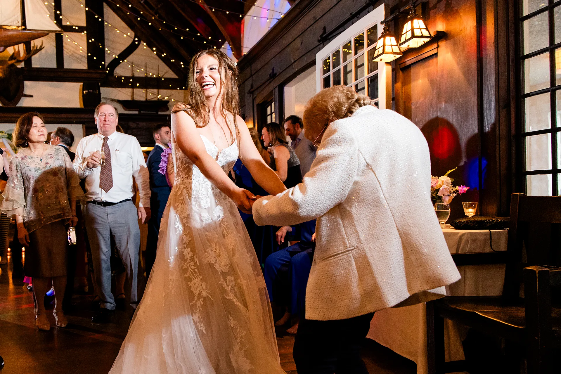 maine wedding photography bethany mike 61 A bride laughs as she dances with her grandmother during a wedding reception at the York Harbor Reading Room in York, Maine.