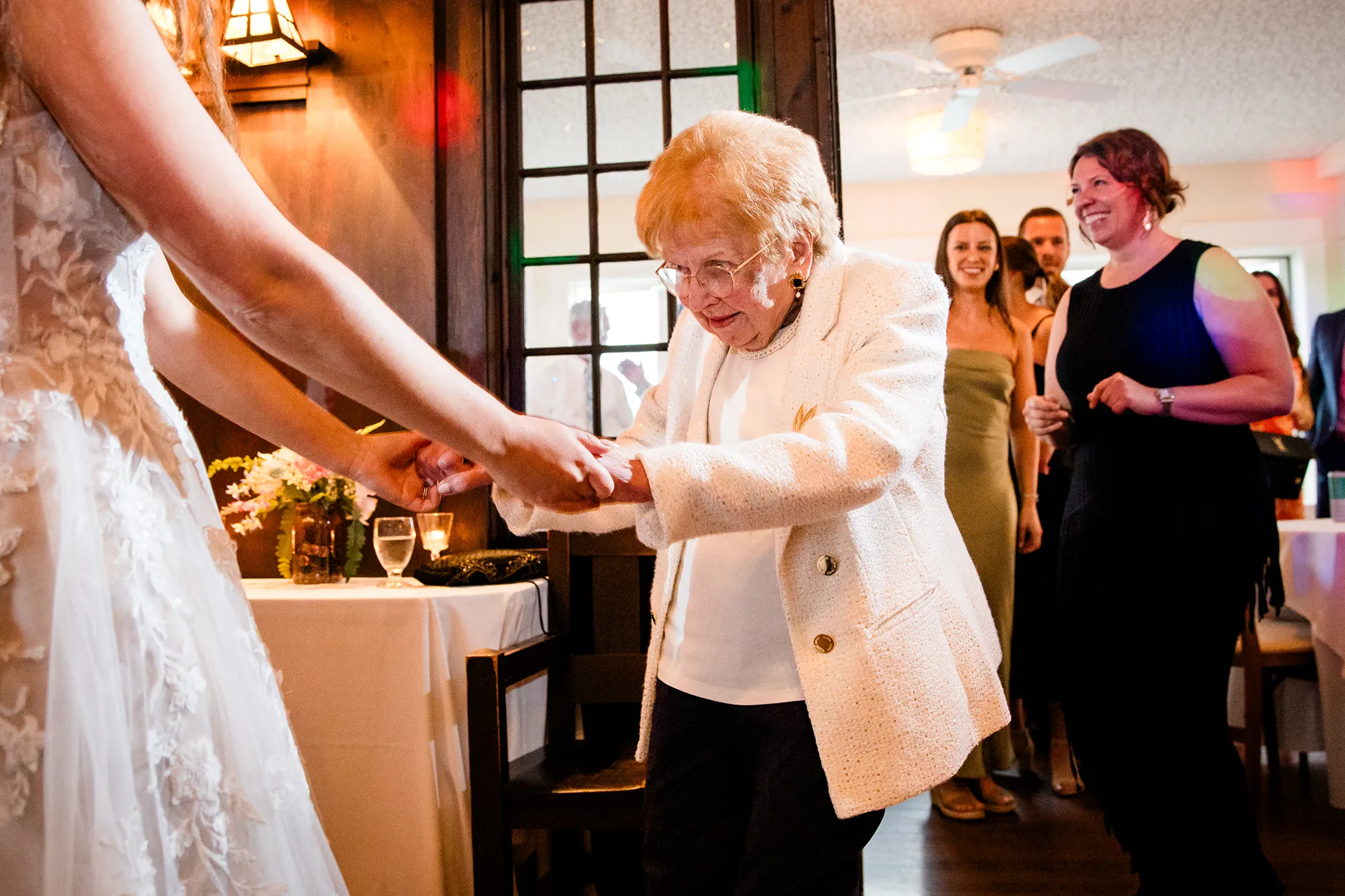 maine wedding photography bethany mike 62 A grandmother dances with a bride during a wedding reception at the York Harbor Reading Room in York, Maine.