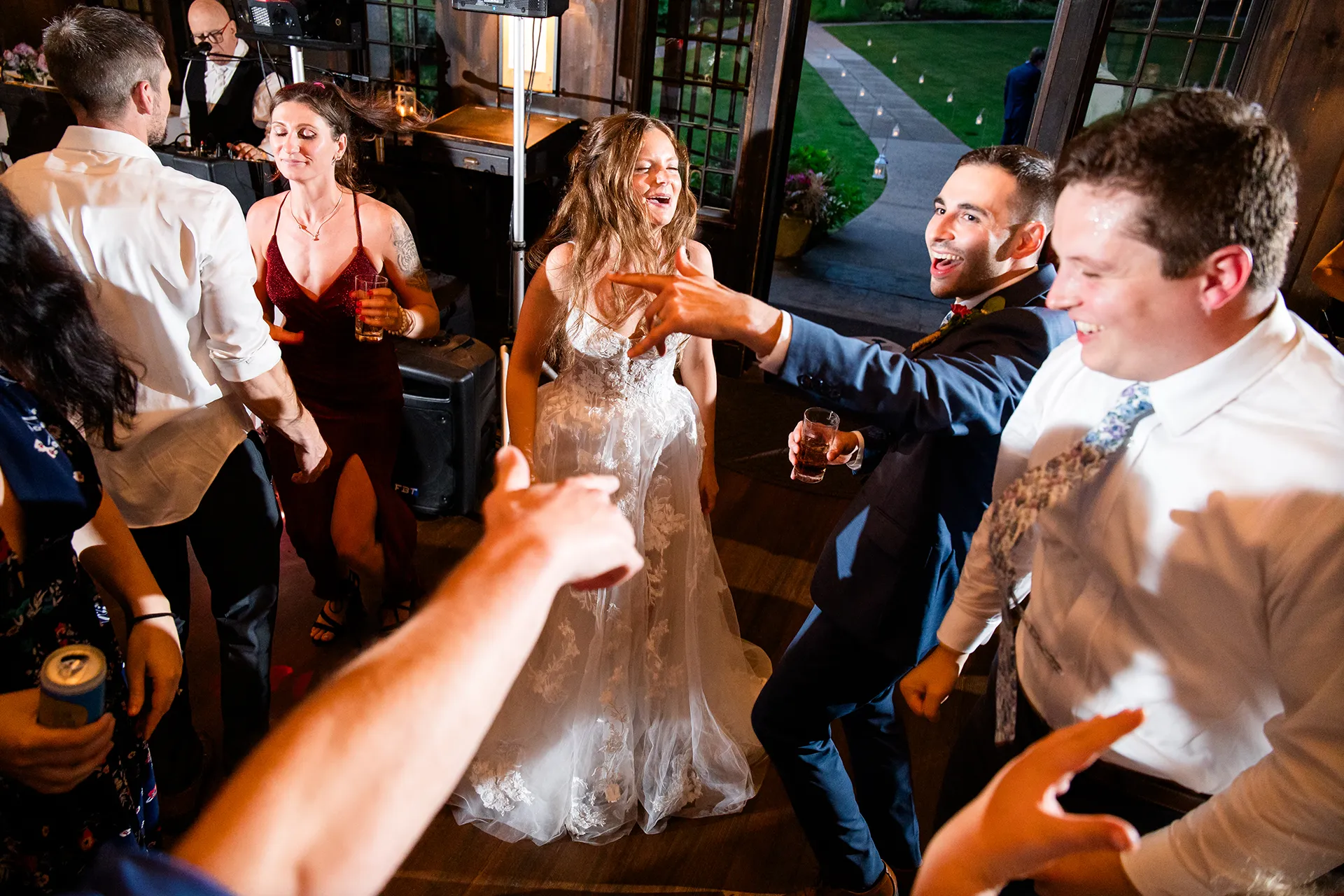 maine wedding photography bethany mike 64 A bride and groom dance with guests during a wedding reception at the York Harbor Reading Room in York, Maine.