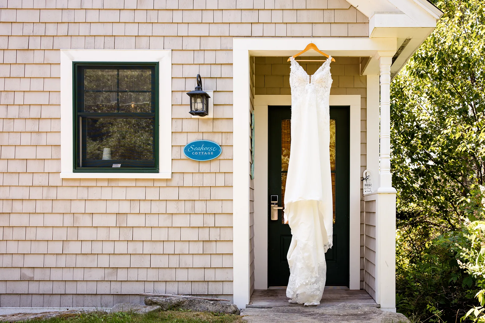 An ivory wedding dress hangs from a doorway at the Seahorse Cottage at the Newagen Seaside Inn in Southport Maine.
