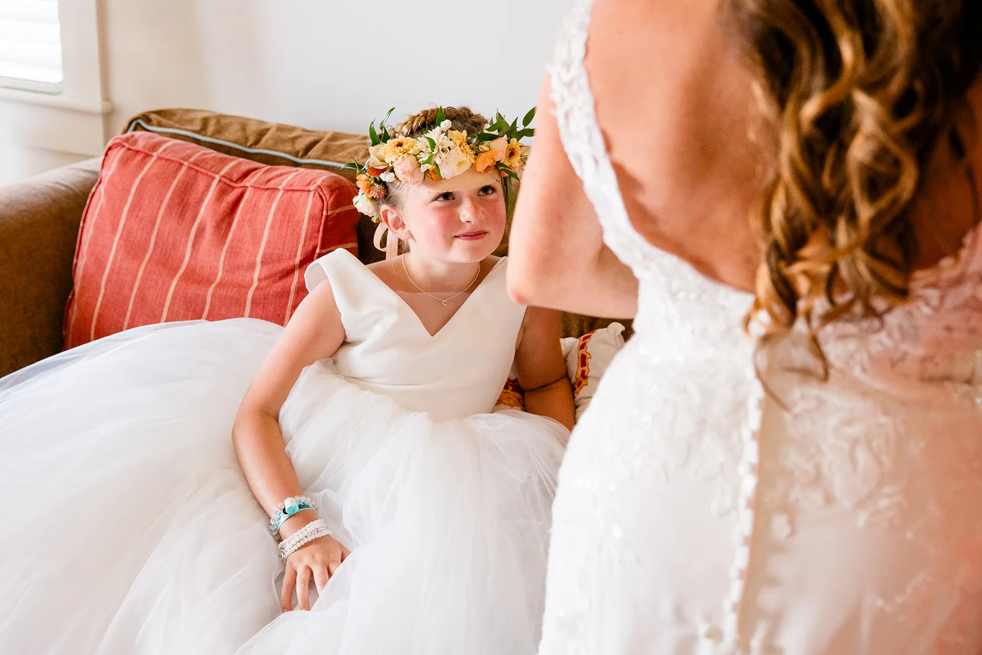 A flower girl smiles as she watches a bride get ready for a wedding at the Newagen Seaside Inn in Southport Maine.