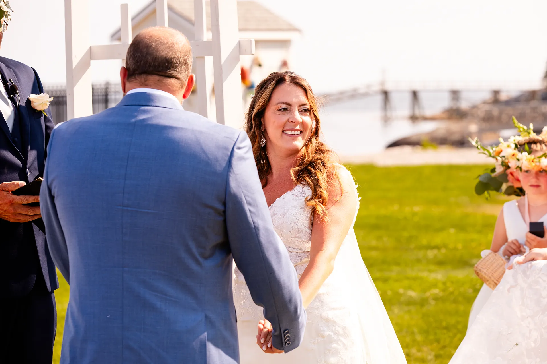 A bride smiles as she looks out at her guests during a wedding ceremony at the Newagen Seaside Inn in Southport Maine.