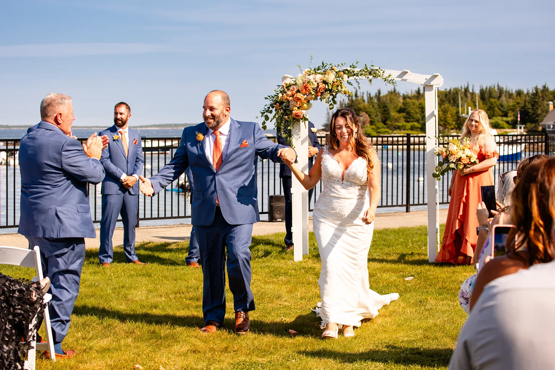 A newly married couple smile as they walk down the aisle after their wedding ceremony at the Newagen Seaside Inn in Southport Maine.