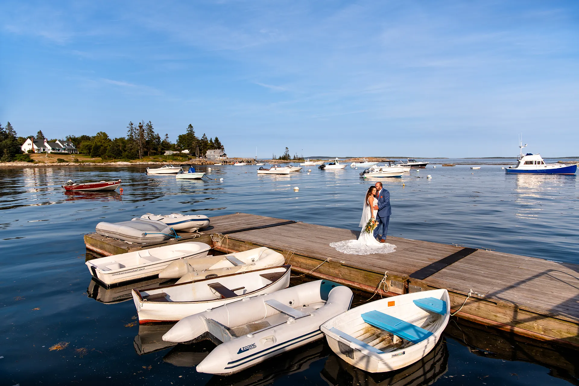 A bride and groom pose on a dock in Southport Maine during wedding portraits at the Newagen Seaside Inn.