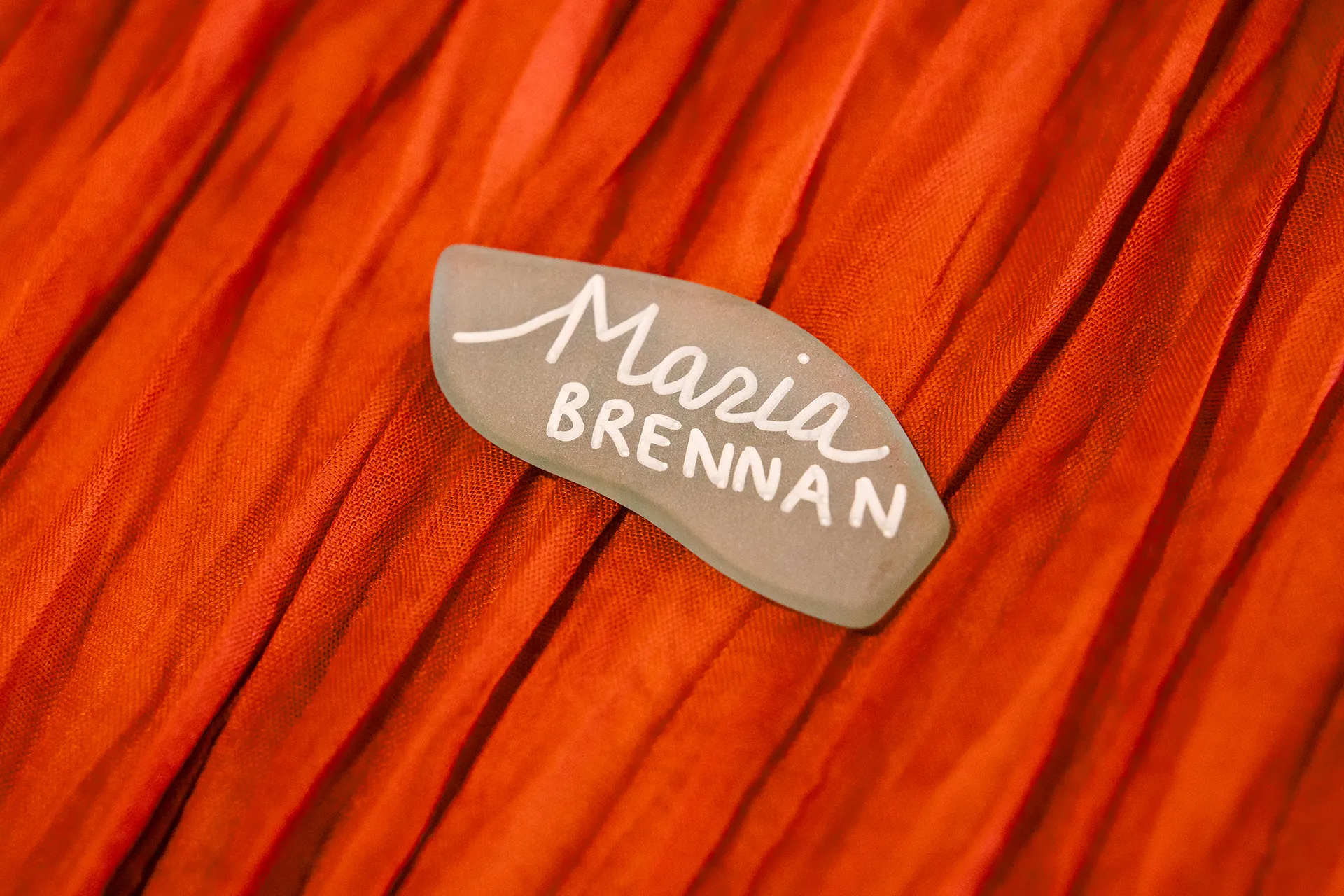 A closeup of rock place card for a wedding reception at the Newagen Seaside Inn in Southport Maine.