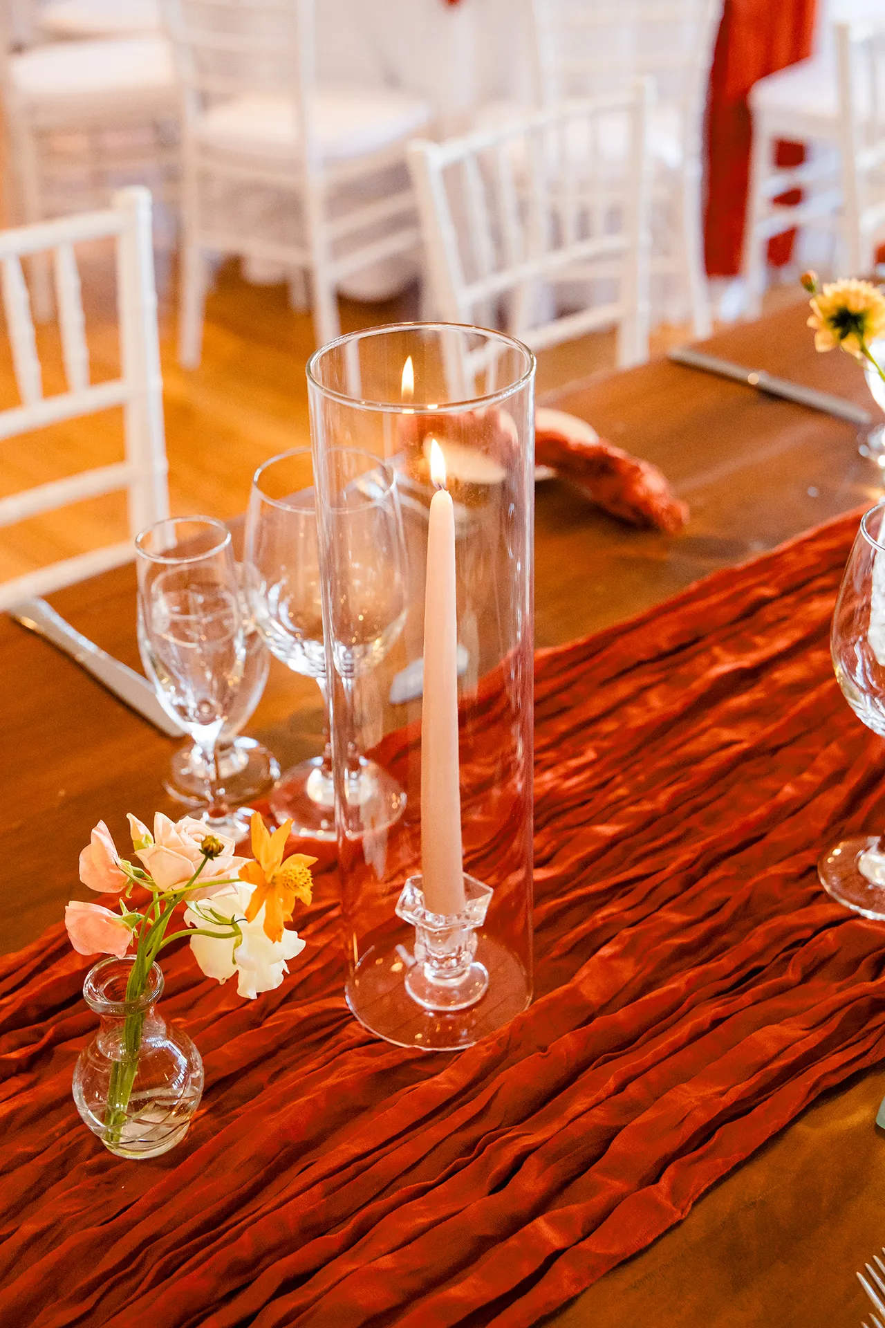 A closeup of a candle and flowers at a wedding reception at the Newagen Seaside Inn in Southport Maine.