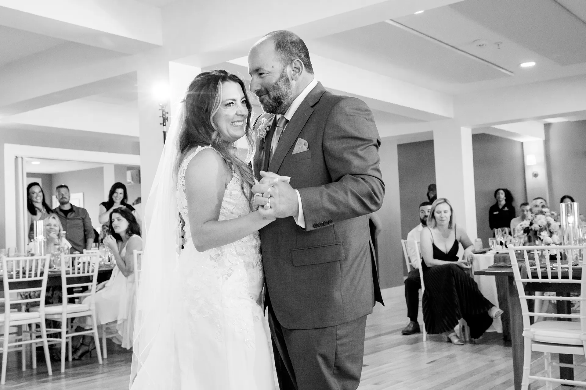 A bride and groom smile as they share a first dance during a wedding reception at the Newagen Seaside Inn in Southport Maine.