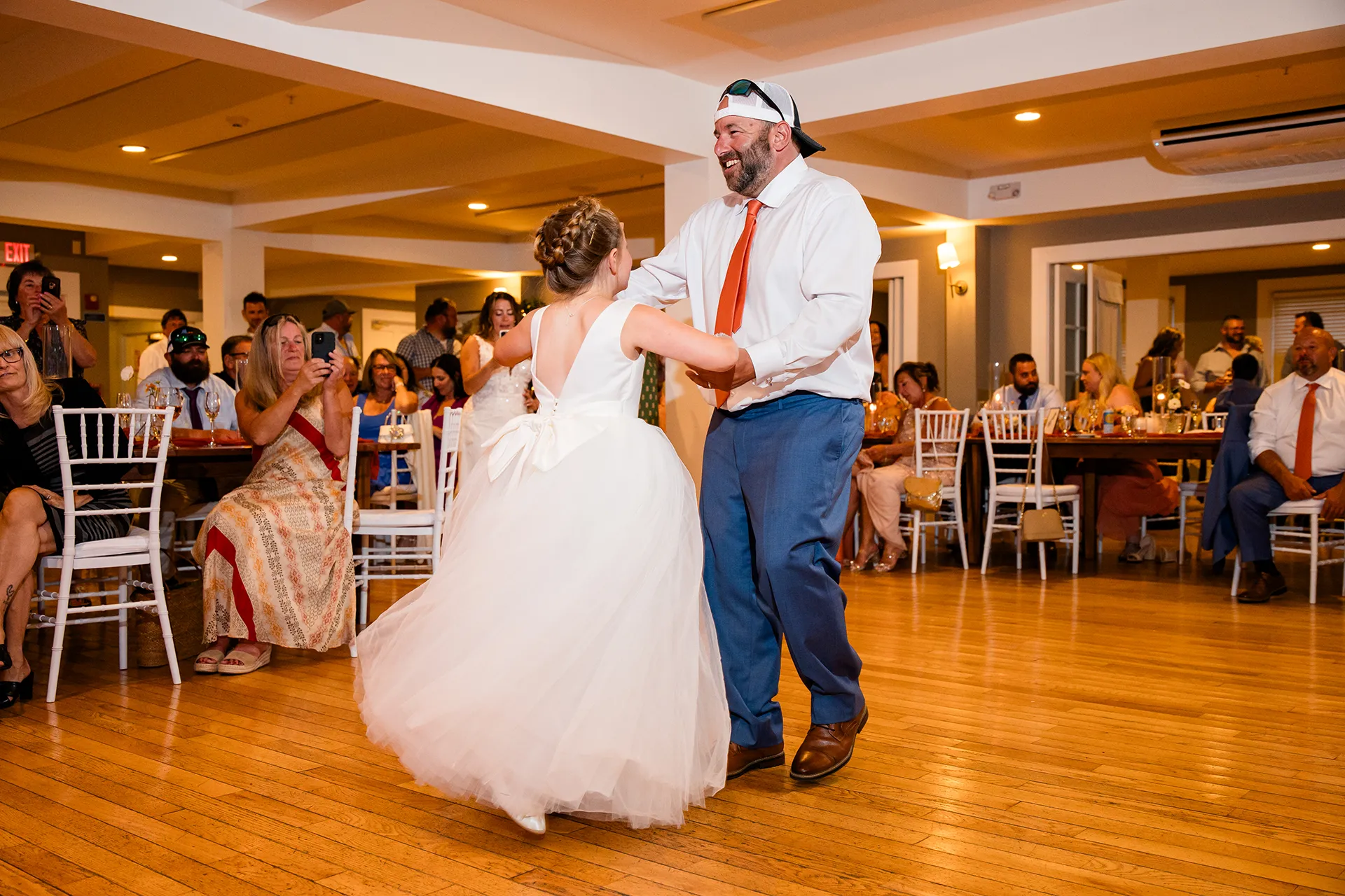 A groom laughs as he dances with a flower girl during a wedding reception at the Newagen Seaside Inn in Southport Maine.