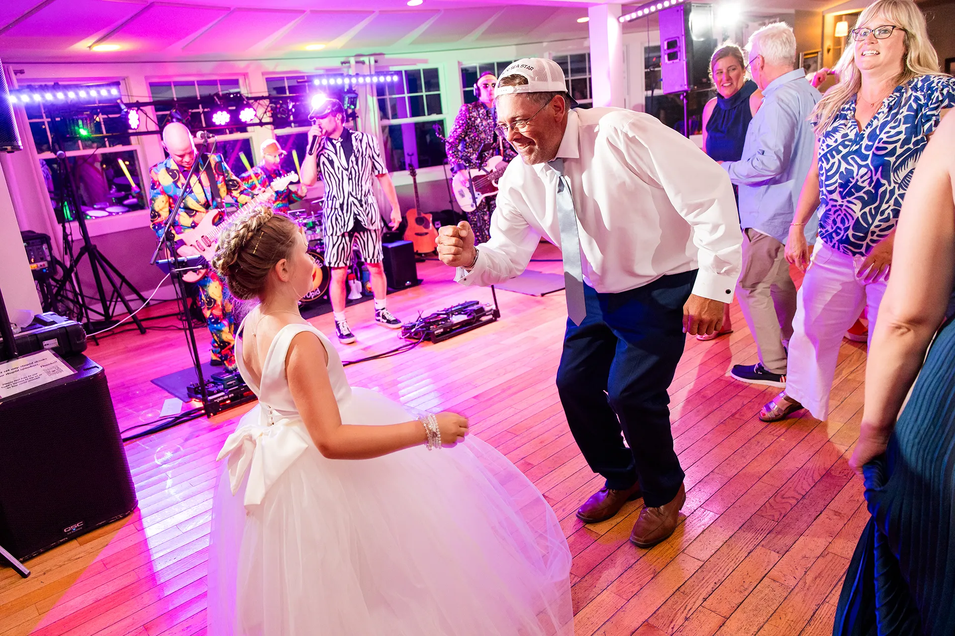 A man dances with a flower girl while the band Something Stupid plays during a wedding reception at the Newagen Seaside Inn in Southport Maine.