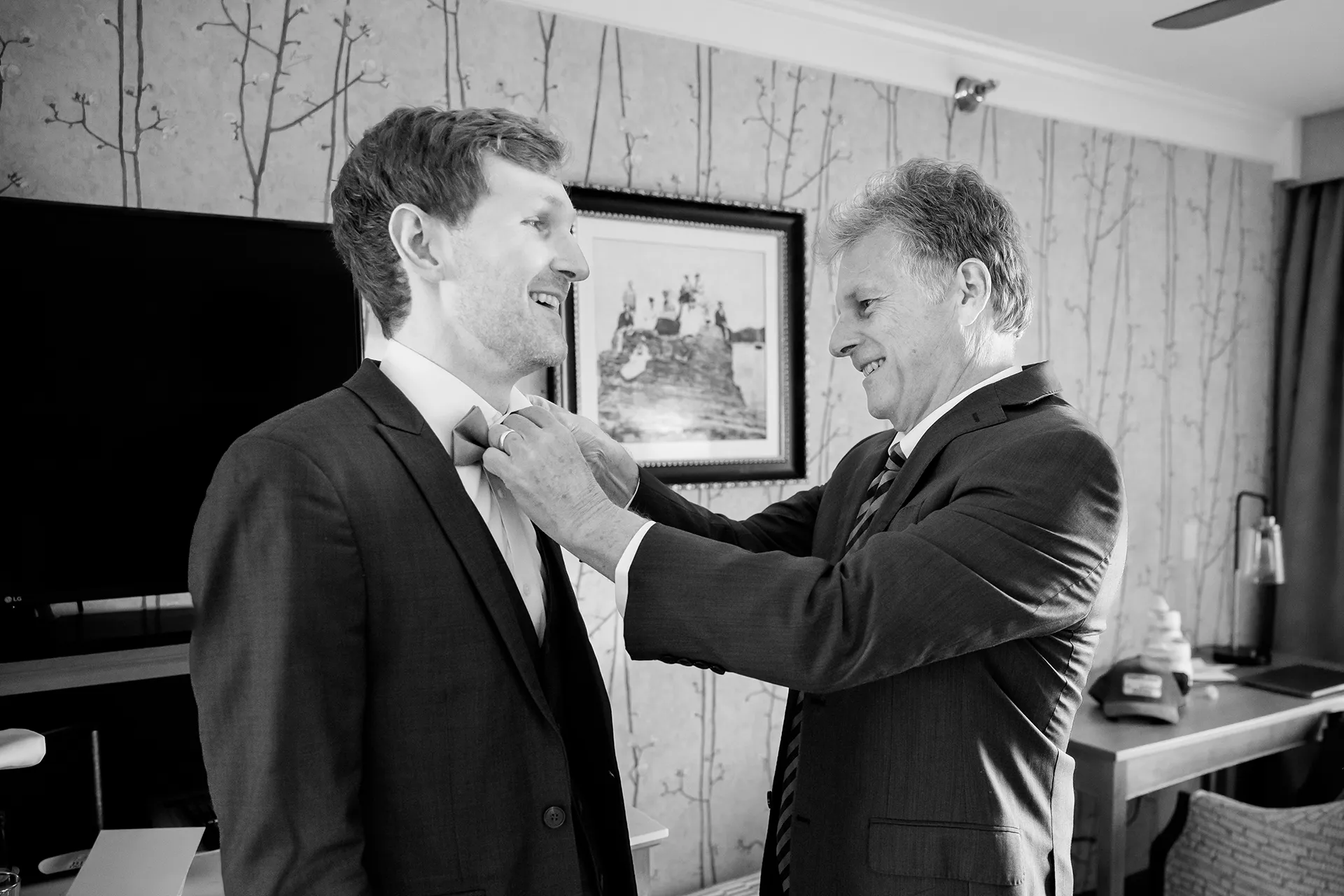 maine wedding photography caroline max 01 A dad helps a groom fix his bowtie for a wedding at the Bar Harbor Inn and Spa in Bar Harbor, Maine.