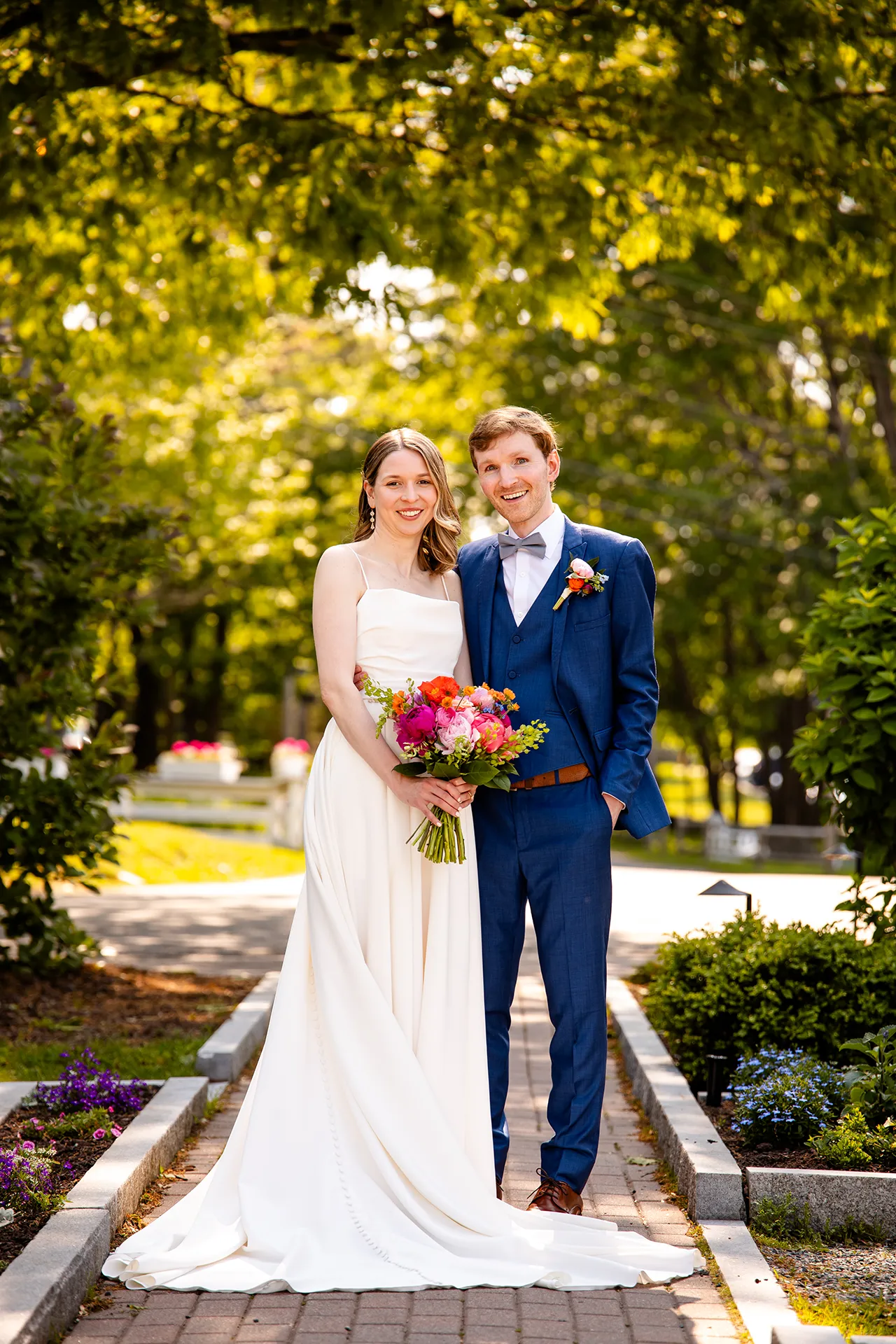 maine wedding photography caroline max 08 A bride and groom smiles and pose for portraits in a garden at the Bar Harbor Inn and Spa in Bar Harbor, Maine.