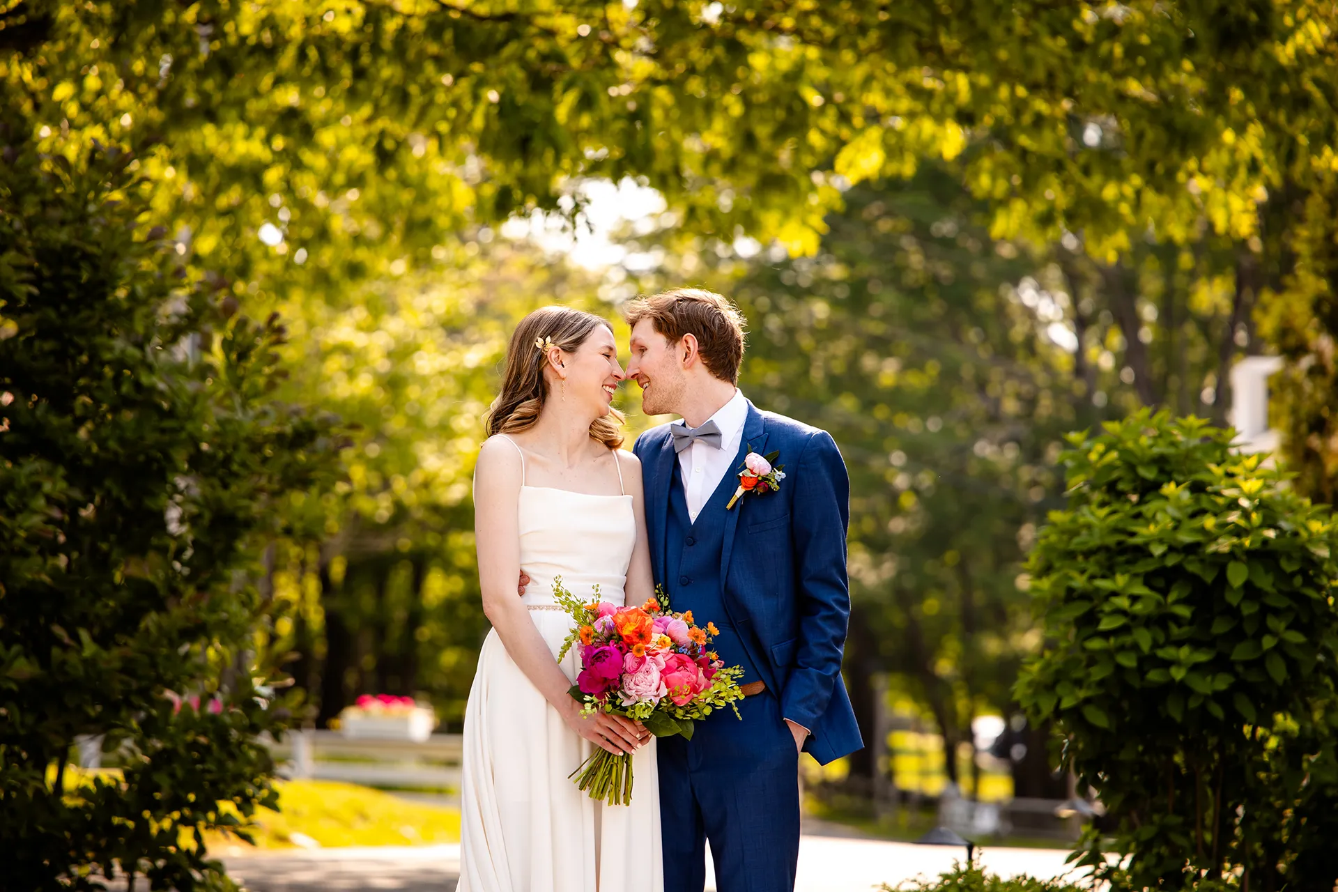 maine wedding photography caroline max 11 A bride and groom smiles and rub noses during wedding portraits in a garden at the Bar Harbor Inn and Spa in Bar Harbor, Maine.