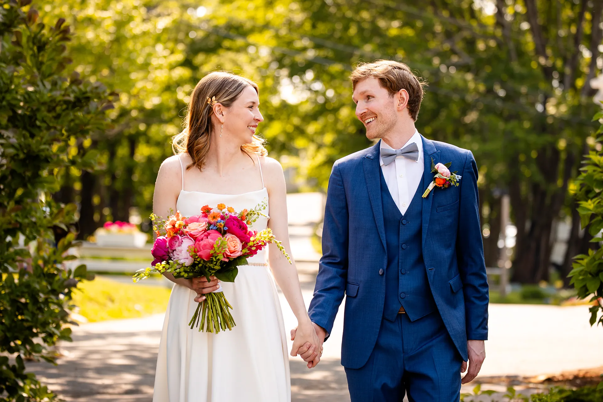 maine wedding photography caroline max 12 A bride and groom hold hands and walk during wedding portraits in a garden at the Bar Harbor Inn and Spa in Bar Harbor, Maine.