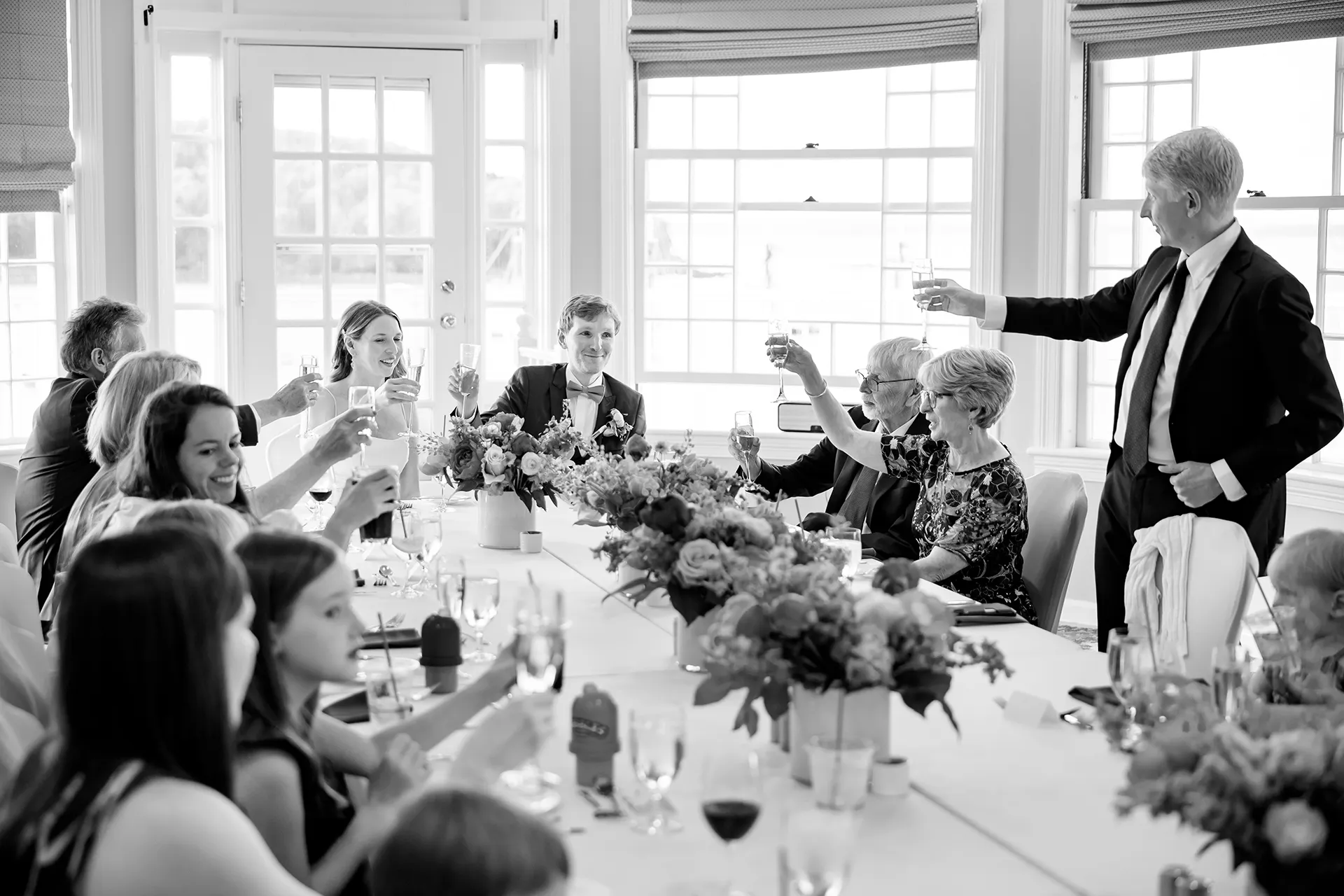maine wedding photography caroline max 31 A toast during a wedding reception in the Porcupine Room at the Bar Harbor Inn and Spa in Bar Harbor, Maine.