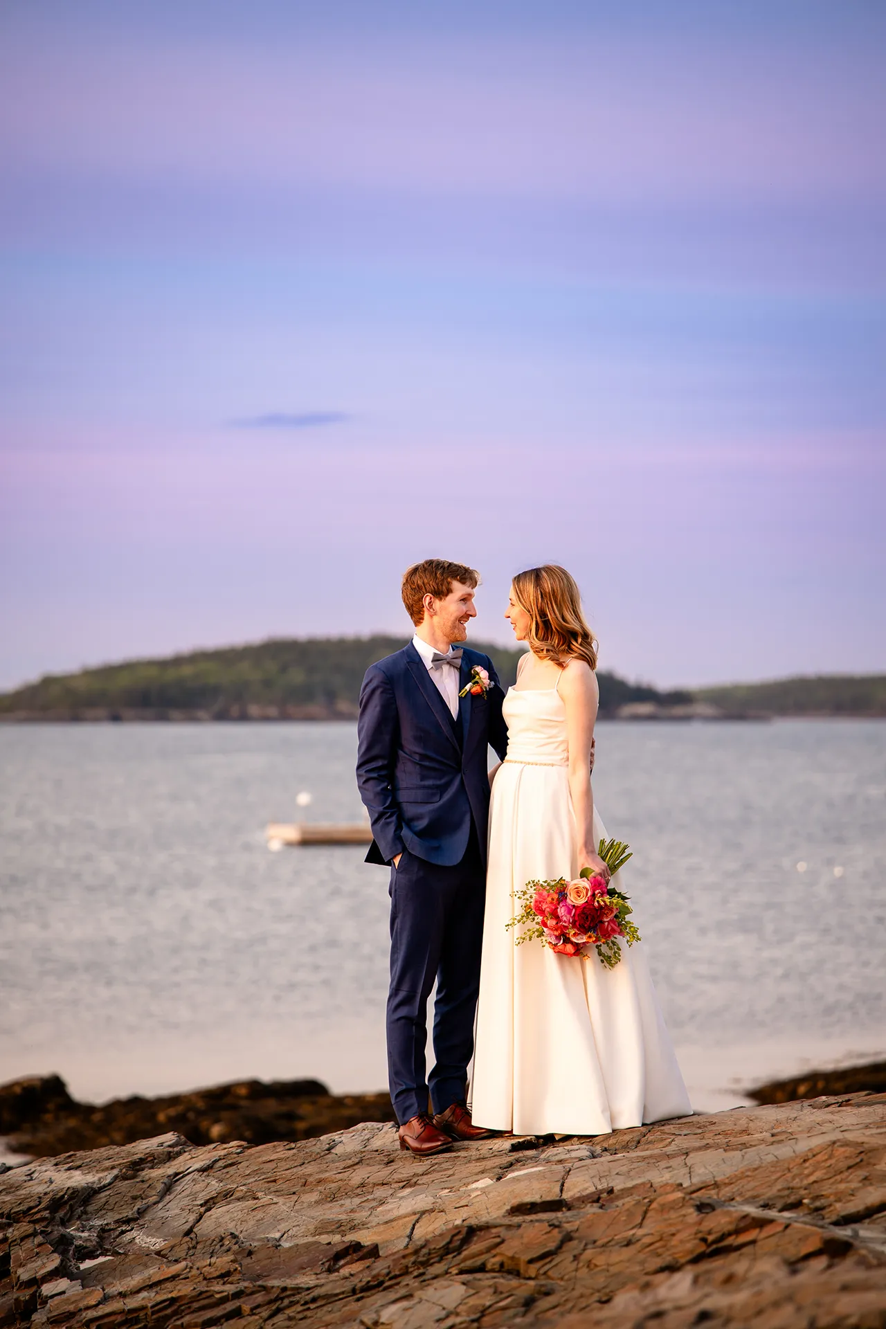 maine wedding photography caroline max 33 A bride and groom smile at each other during wedding portraits at the Bar Harbor Inn and Spa in Bar Harbor, Maine.
