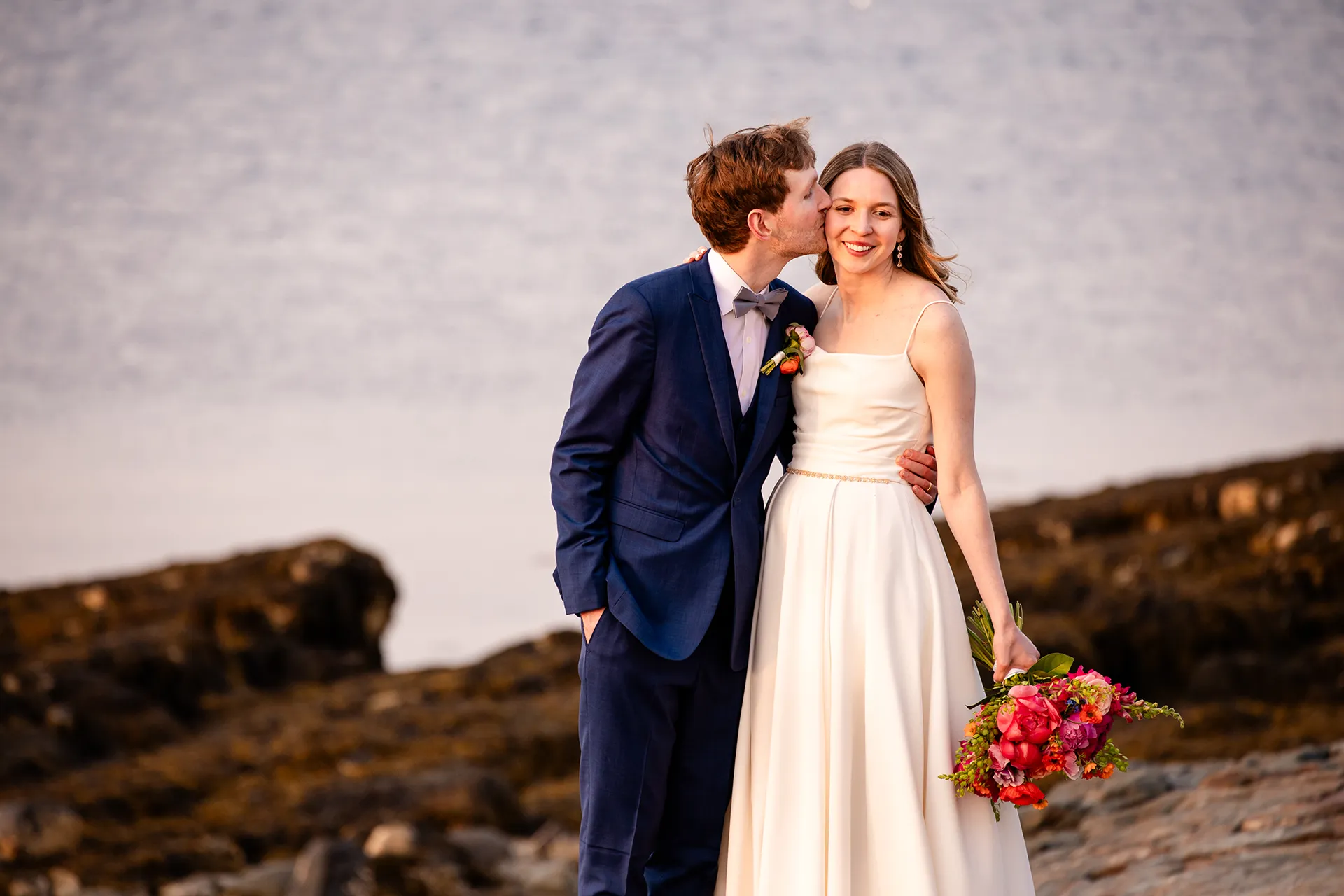 maine wedding photography caroline max 36 A groom kisses a bride on the cheek during wedding portraits at the Bar Harbor Inn and Spa in Bar Harbor, Maine.