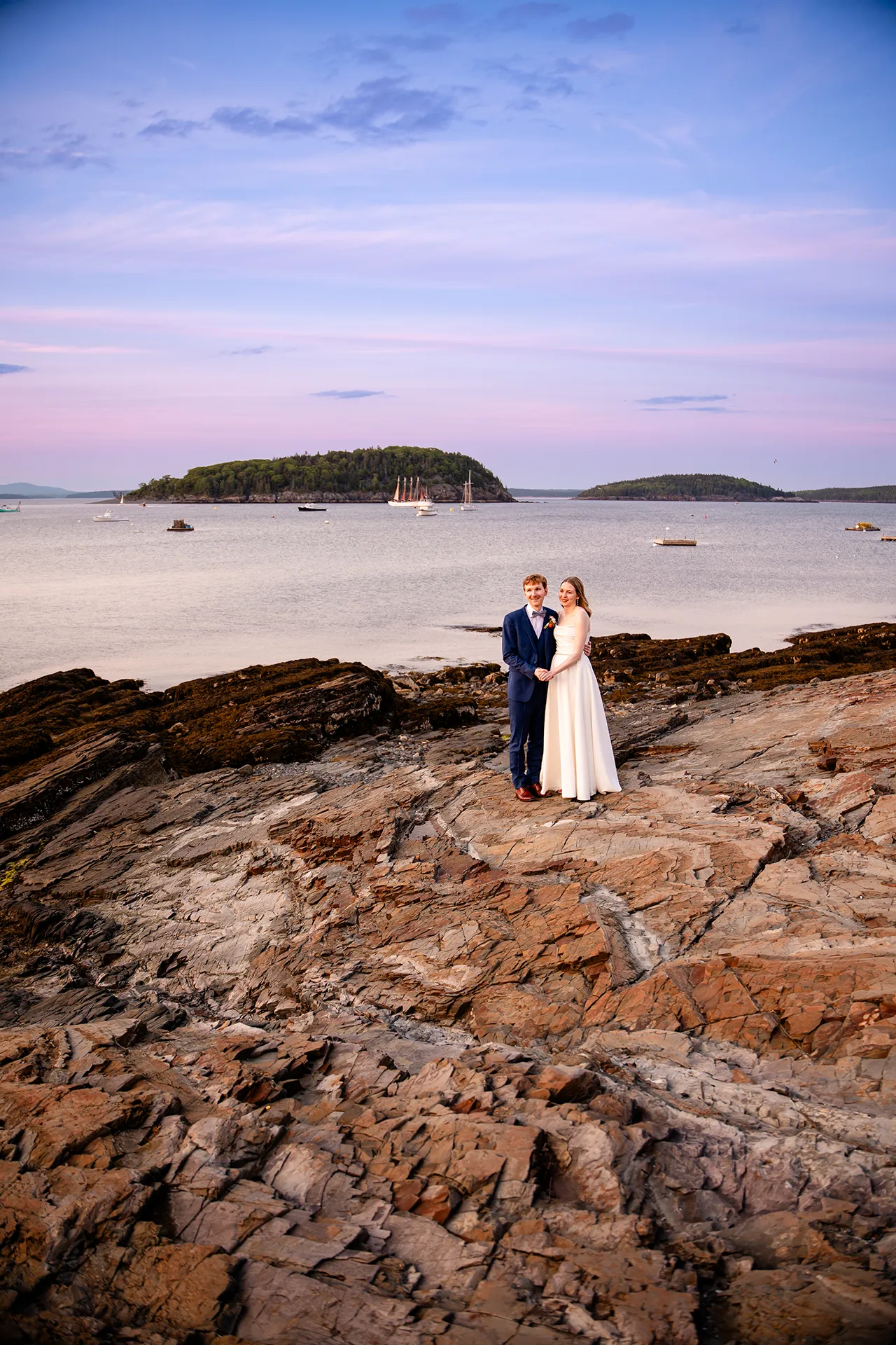 maine wedding photography caroline max 39 A bride and groom hold hands as they pose for wedding portraits at the Bar Harbor Inn and Spa in Bar Harbor, Maine.