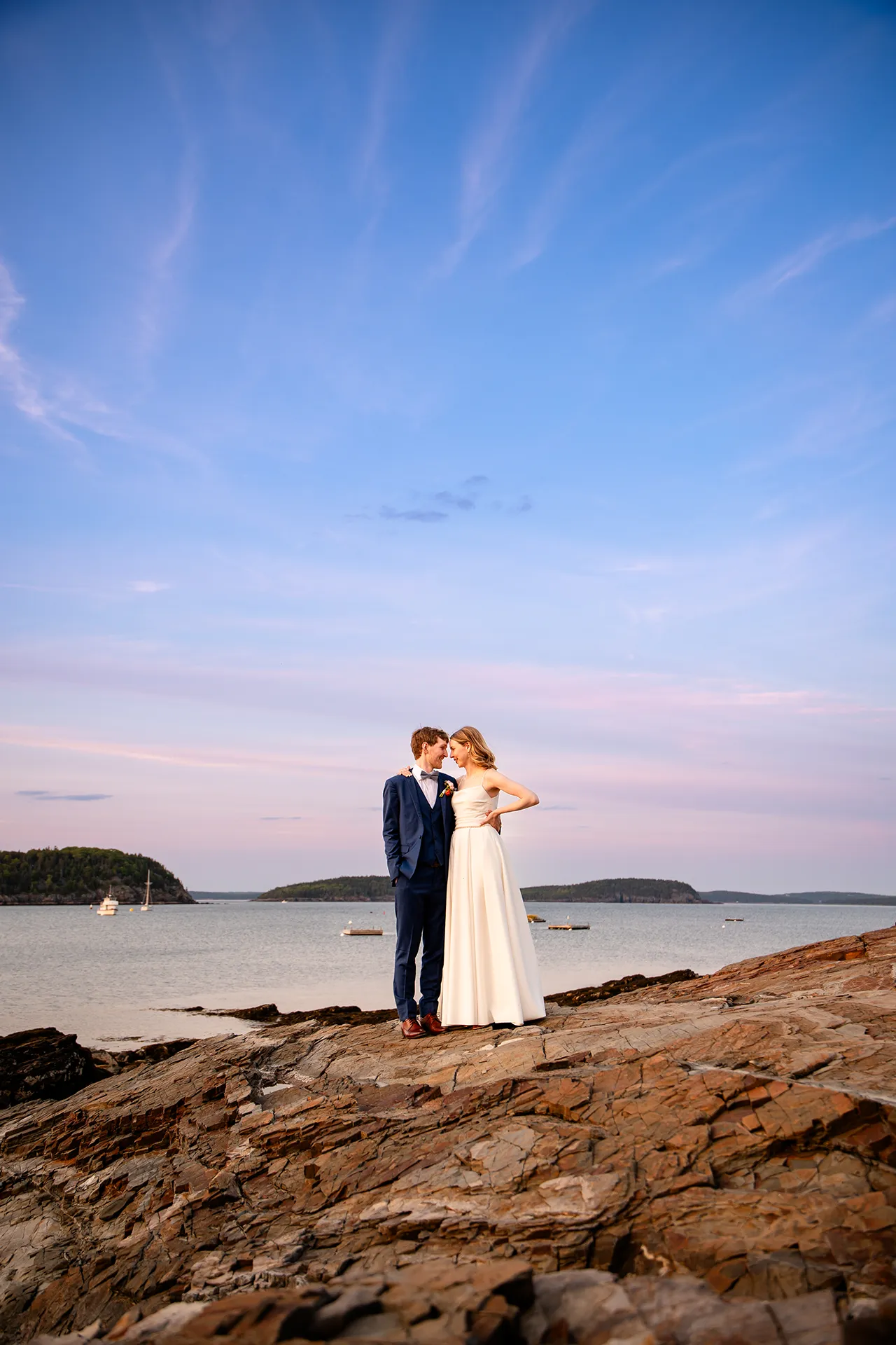 maine wedding photography caroline max 40 A bride and groom rest their heads together during wedding portraits in front of Frenchman's Bay in Bar Harbor, Maine.
