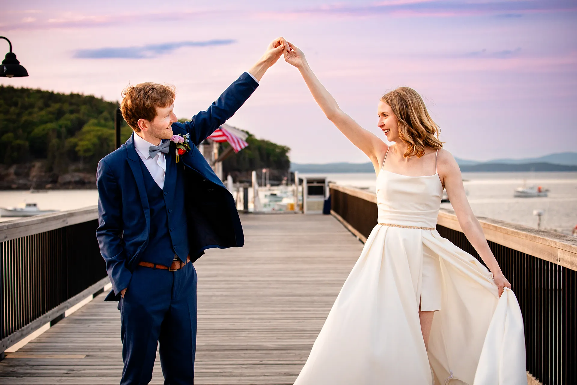maine wedding photography caroline max 45 A bride and groom hold hands and smile at each other during wedding portraits at the Bar Harbor Inn and Spa in Bar Harbor, Maine.
