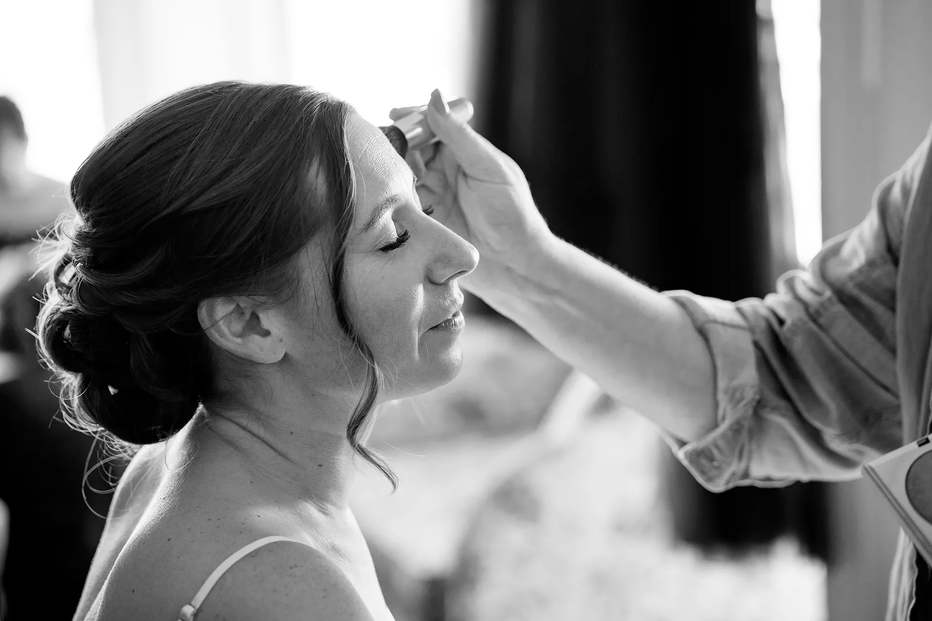 A brides gets her makeup done as she gets ready for a wedding at the Atlantic Oceanside Hotel & Event Center in Bar Harbor, Maine.