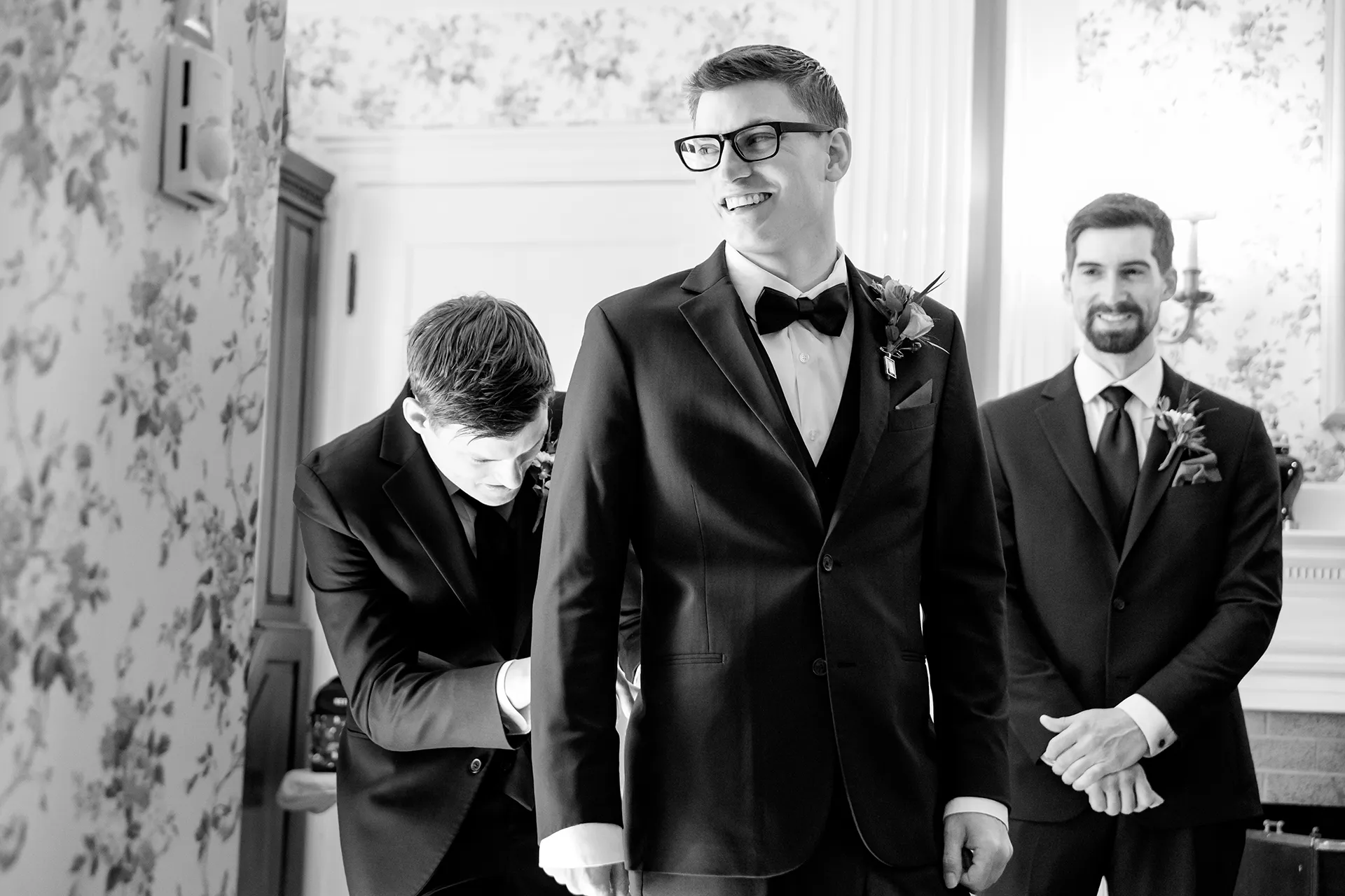 A groom laughs as a groomsman helps him gets ready for a wedding at the Atlantic Oceanside Hotel & Event Center in Bar Harbor, Maine.