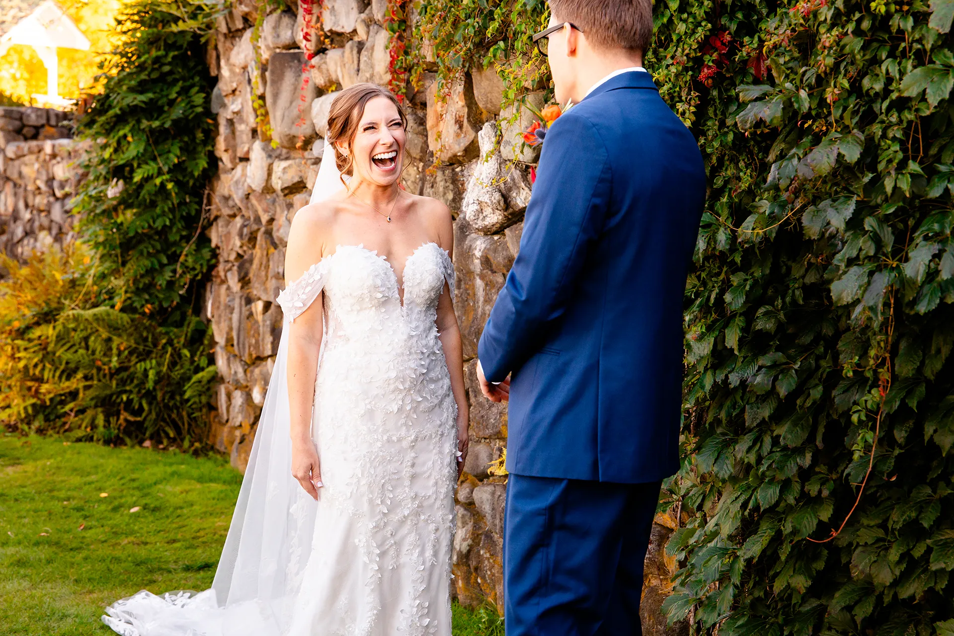 A bride laughs as she sees a groom for the first time in the side garden at the Willows on the property of the Atlantic Oceanside Hotel & Event Center.