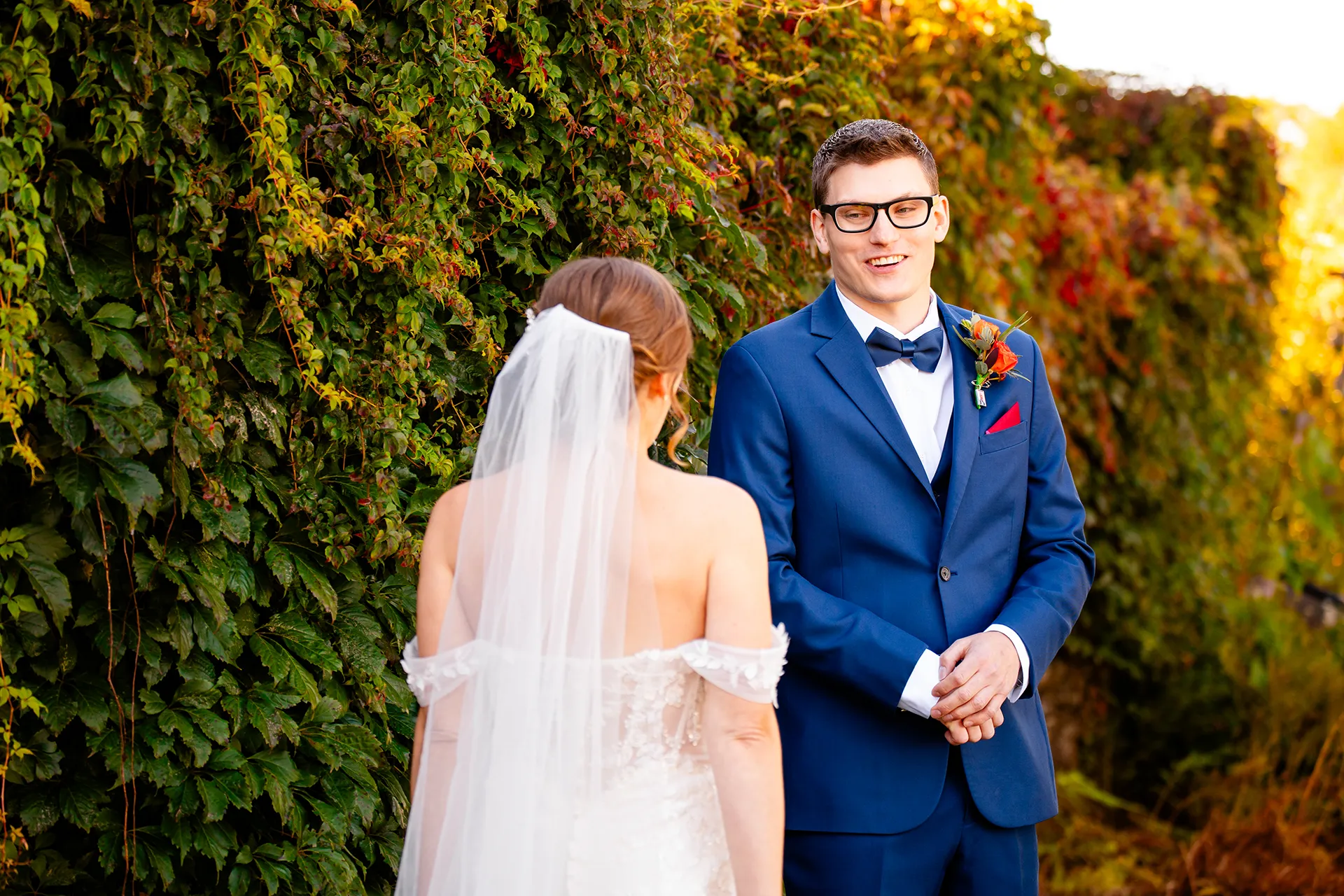 A groom smiles as he sees a bride for the first time in the side garden at the Willows on the property of the Atlantic Oceanside Hotel & Event Center.
