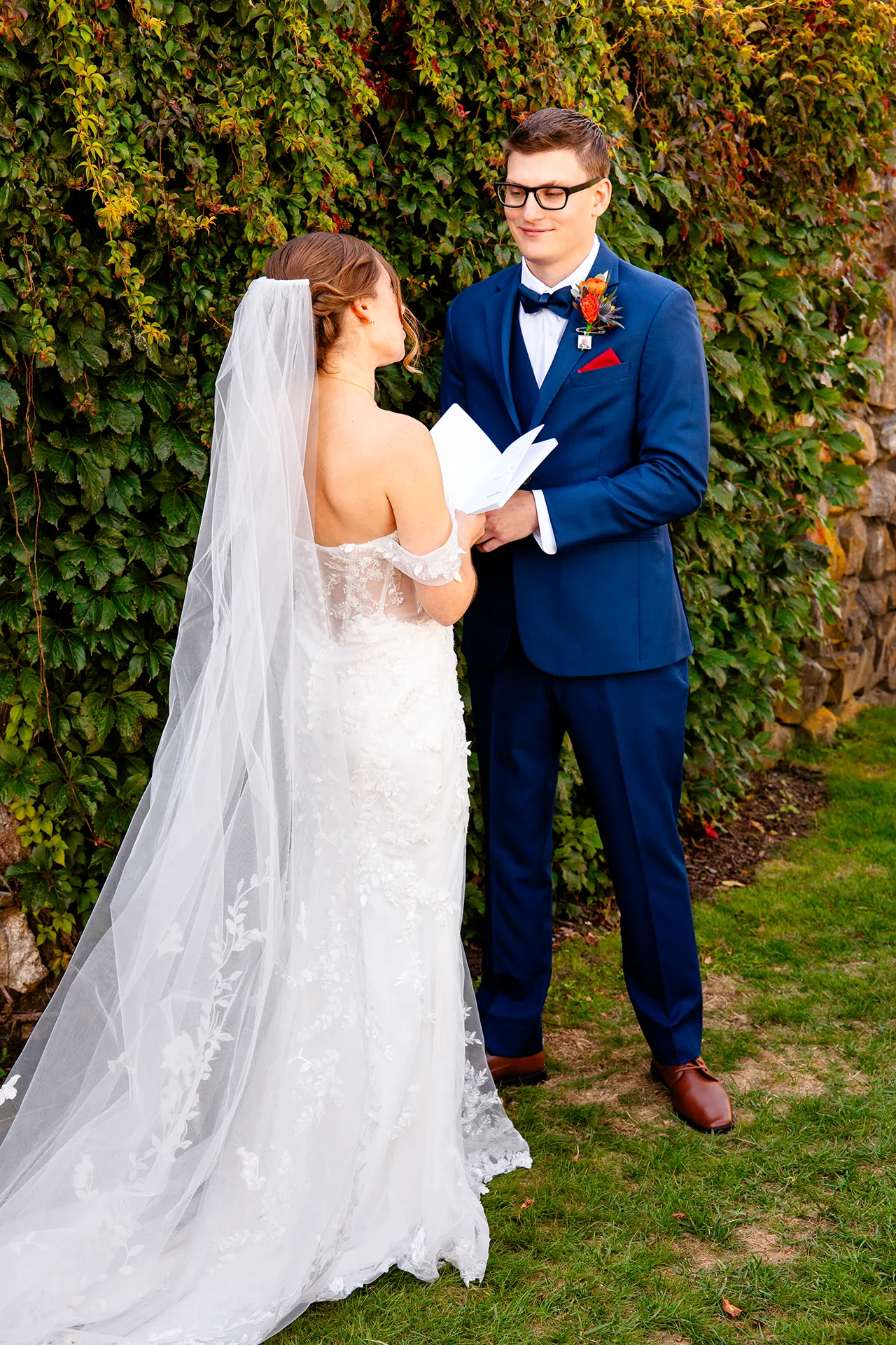 A bride shares her vows with a groom in the side garden at the Willows on the property of the Atlantic Oceanside Hotel & Event Center in Bar Harbor, Maine.