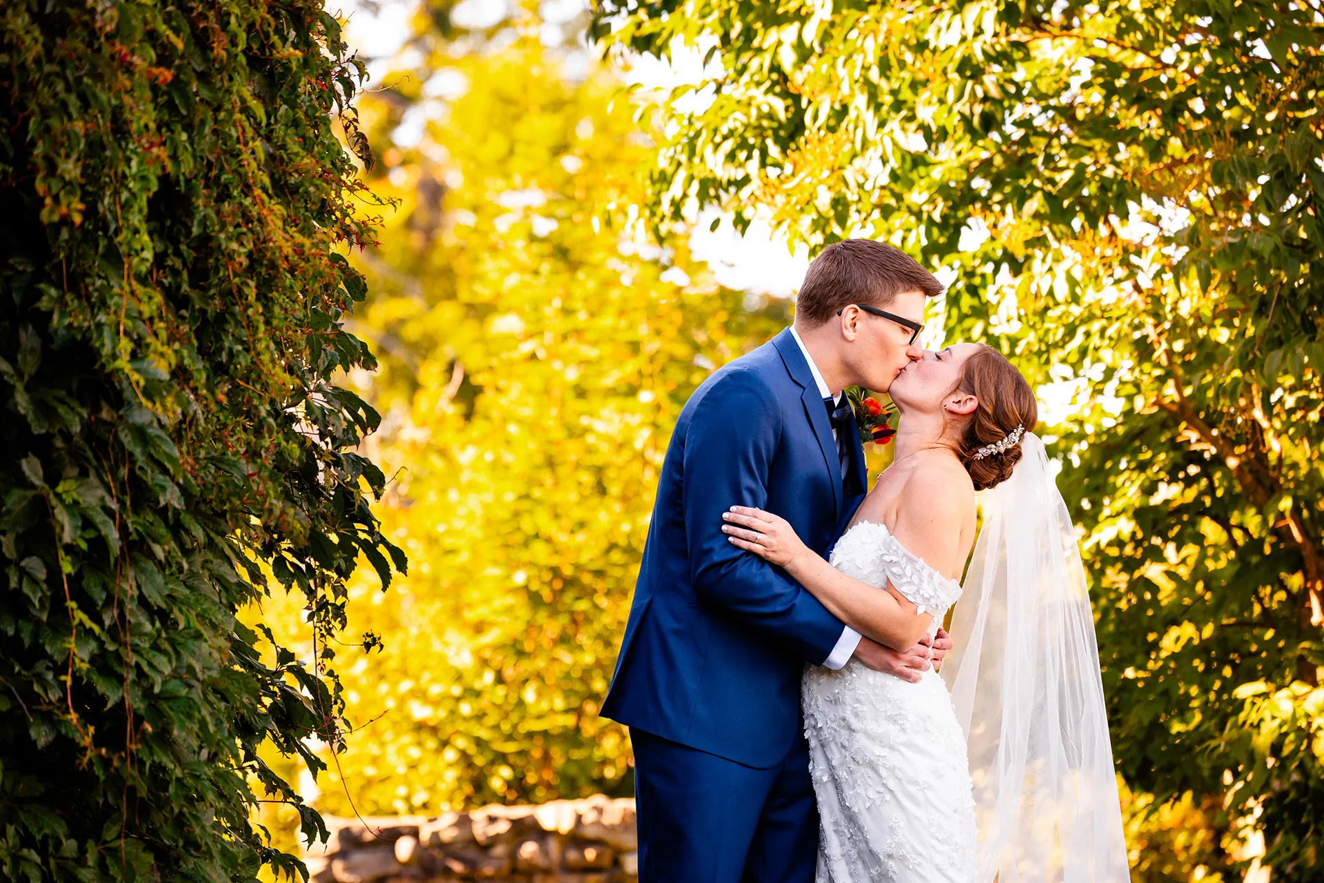 A bride and groom kiss in the side garden at the Willows on the property of the Atlantic Oceanside Hotel & Event Center in Bar Harbor, Maine.