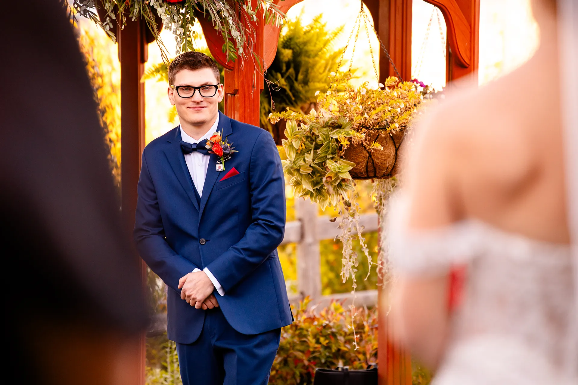 A groom smiles as he watches a bride walk down the aisle during a wedding ceremony at the Atlantic Oceanside Hotel & Event Center in Bar Harbor, Maine.