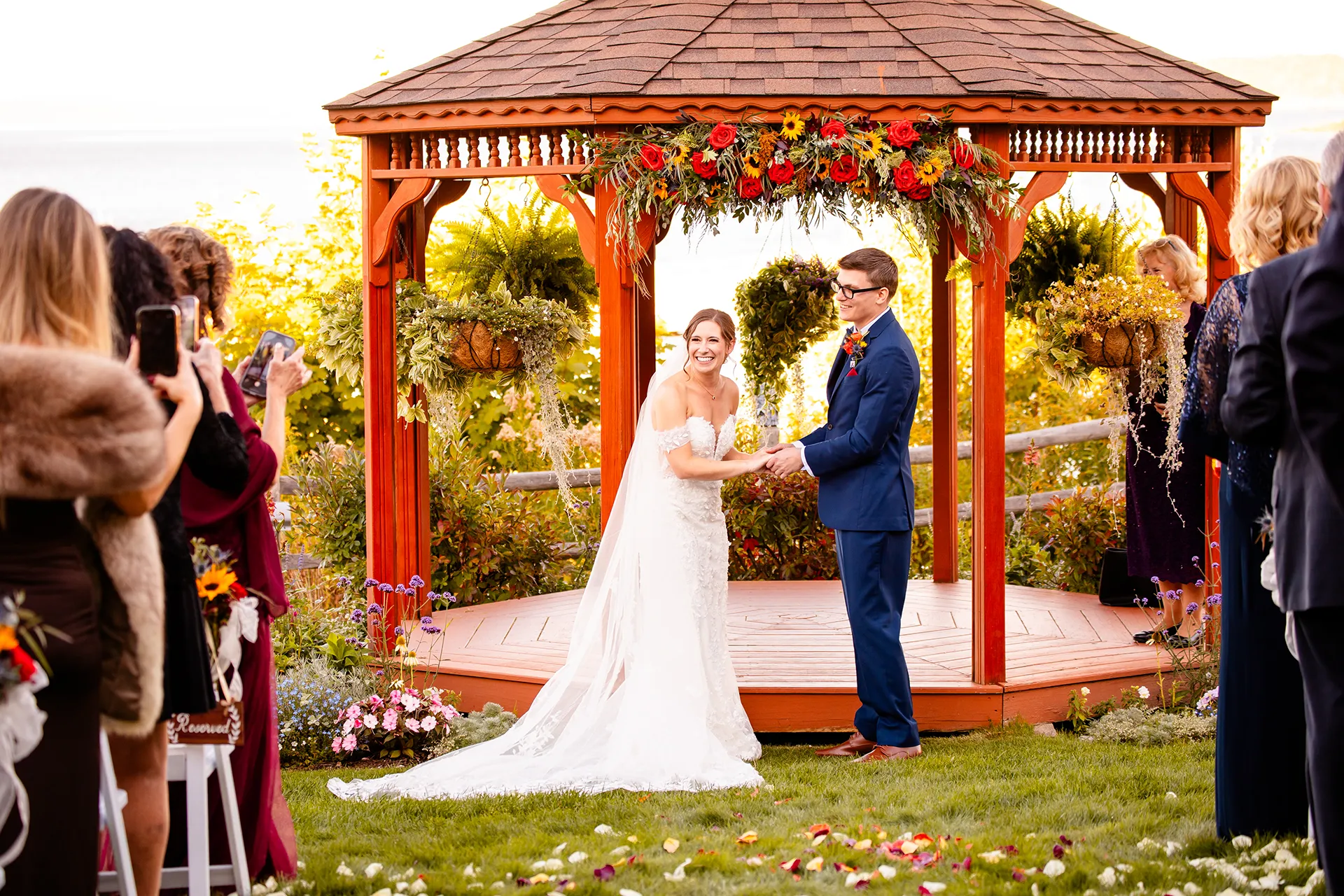 A bride and groom smile at their guests during a wedding ceremony at the Atlantic Oceanside Hotel & Event Center in Bar Harbor, Maine.