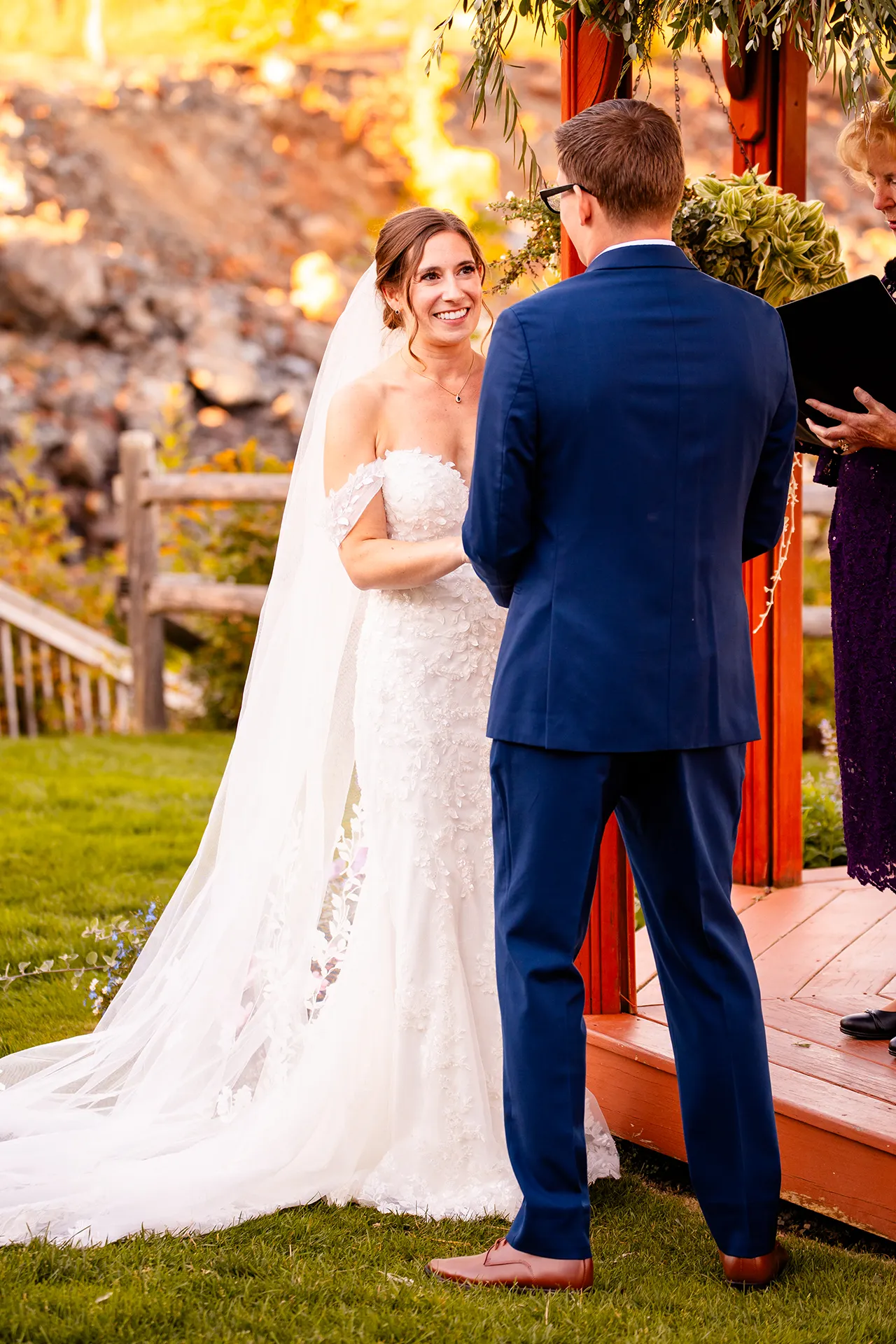 A bride smiles at a groom during a wedding ceremony at the Atlantic Oceanside Hotel & Event Center in Bar Harbor, Maine.
