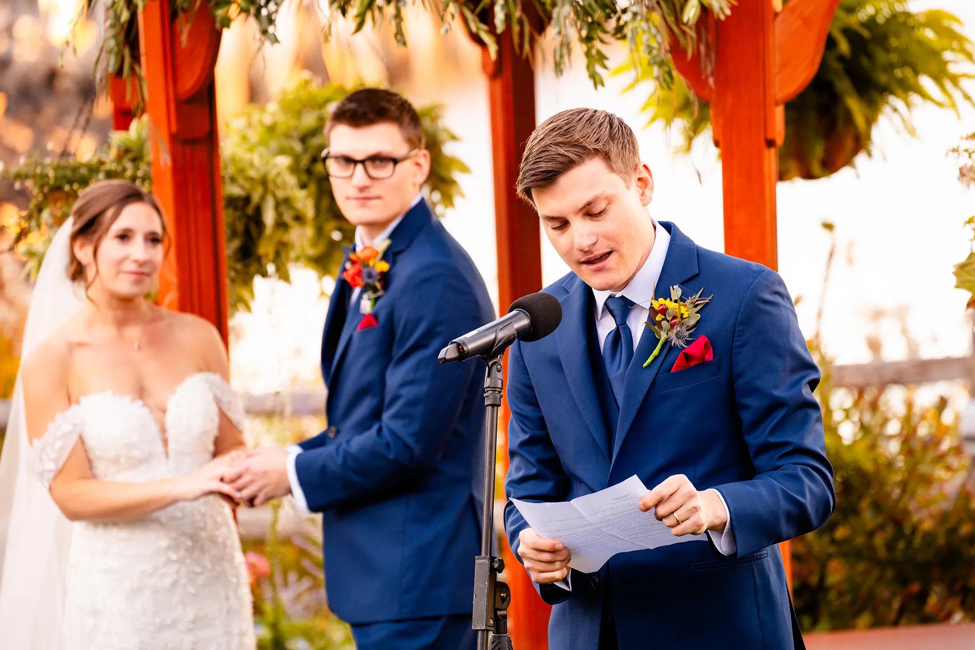 A groomsman gives a reading while a bride and groom listen during a wedding ceremony at the Atlantic Oceanside Hotel & Event Center in Bar Harbor, Maine.