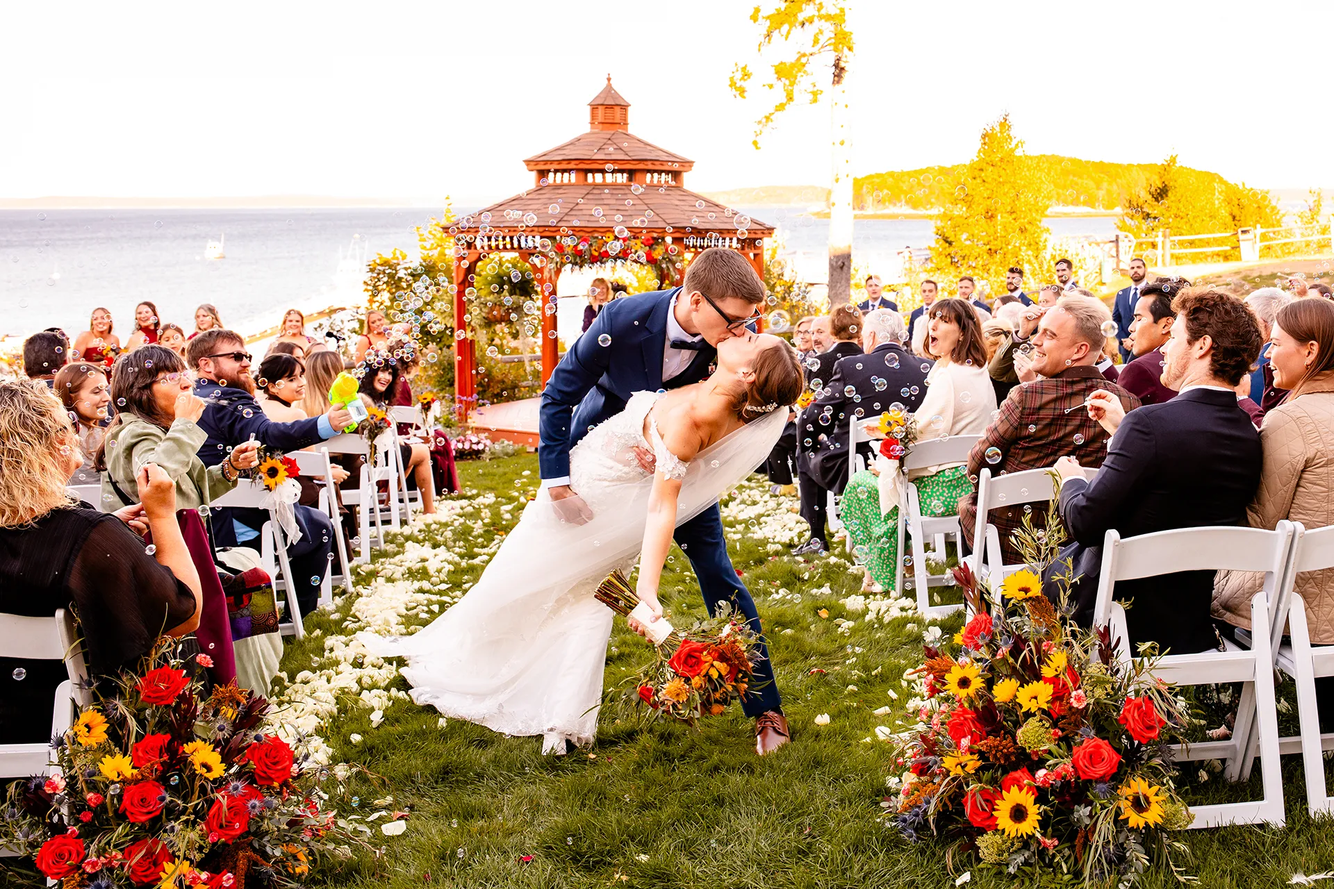 A groom dips a bride as guests blow bubbles after a wedding ceremony at the Atlantic Oceanside Hotel & Event Center in Bar Harbor, Maine.