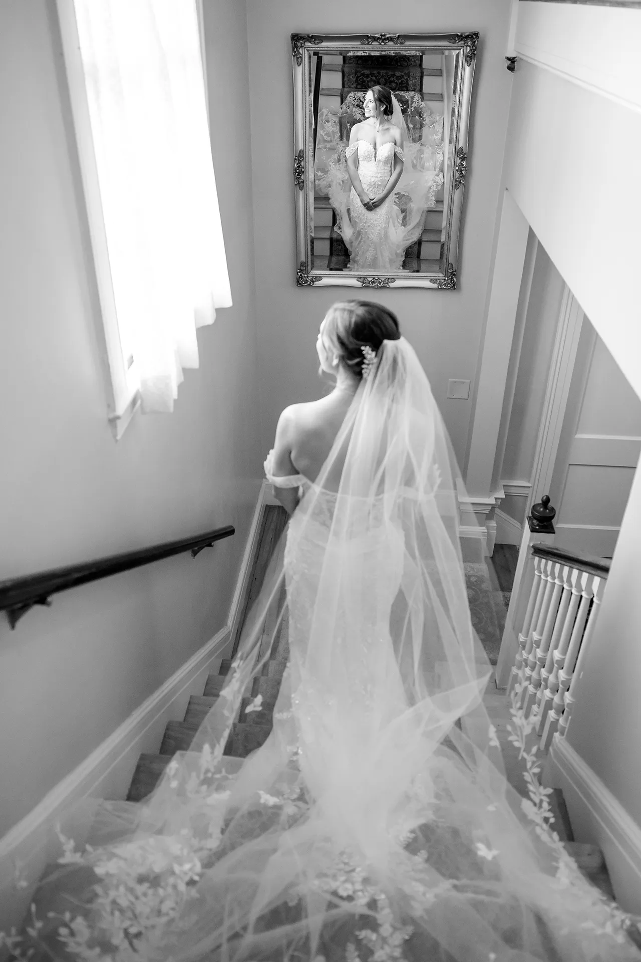 A brides poses on the stairs of the Willows on the property at the Atlantic Oceanside Hotel & Event Center in Bar Harbor, Maine.