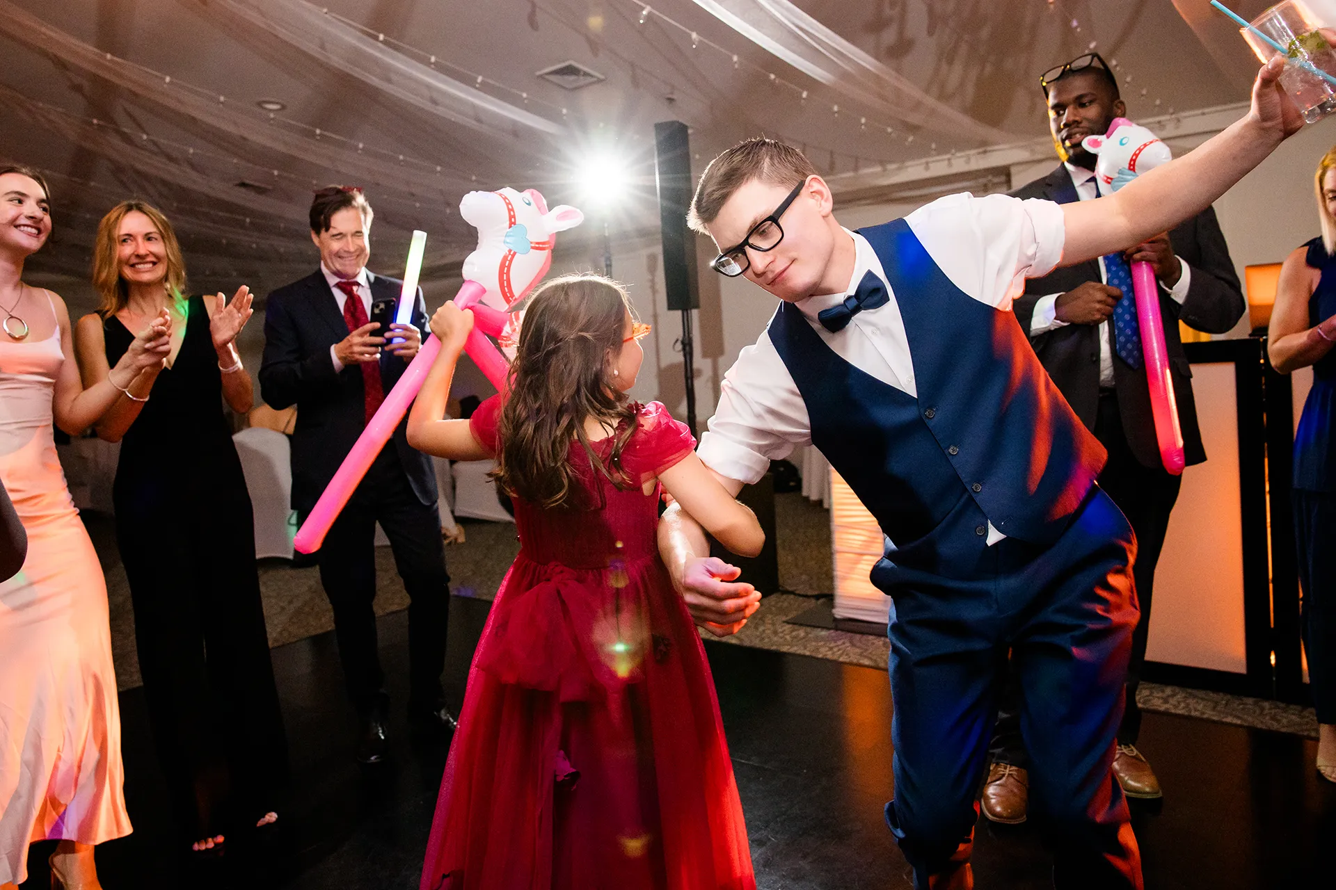 A groom dances with a flower girl during a wedding reception at the Atlantic Oceanside Hotel & Event Center in Bar Harbor, Maine.